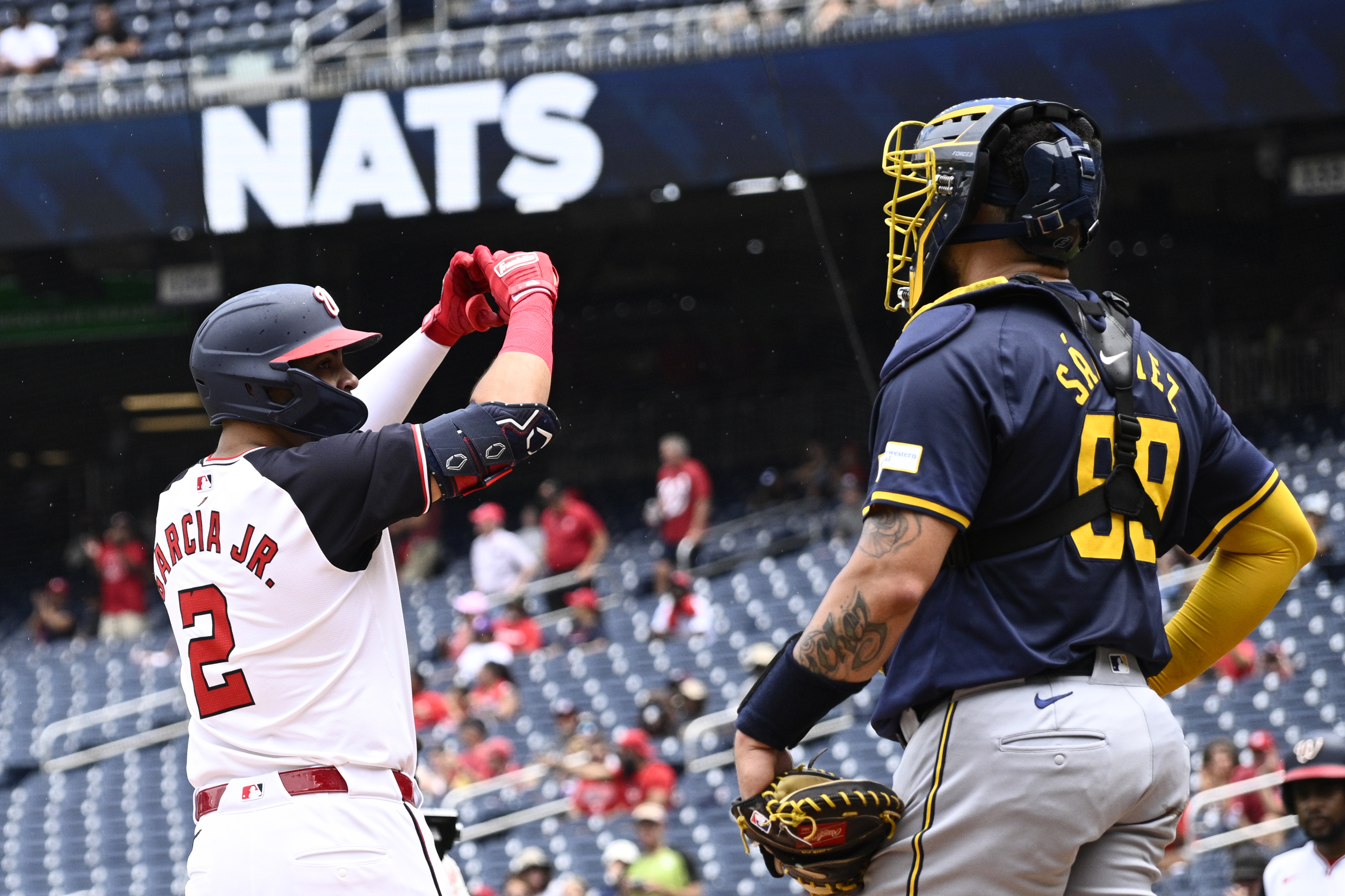 Washington Nationals' Luis Garcia Jr. (2) celebrates after his home run in front of Milwaukee Brewers catcher Gary Sanchez (99) during the first inning of a baseball game, Sunday, Aug. 4, 2024, in Washington. 