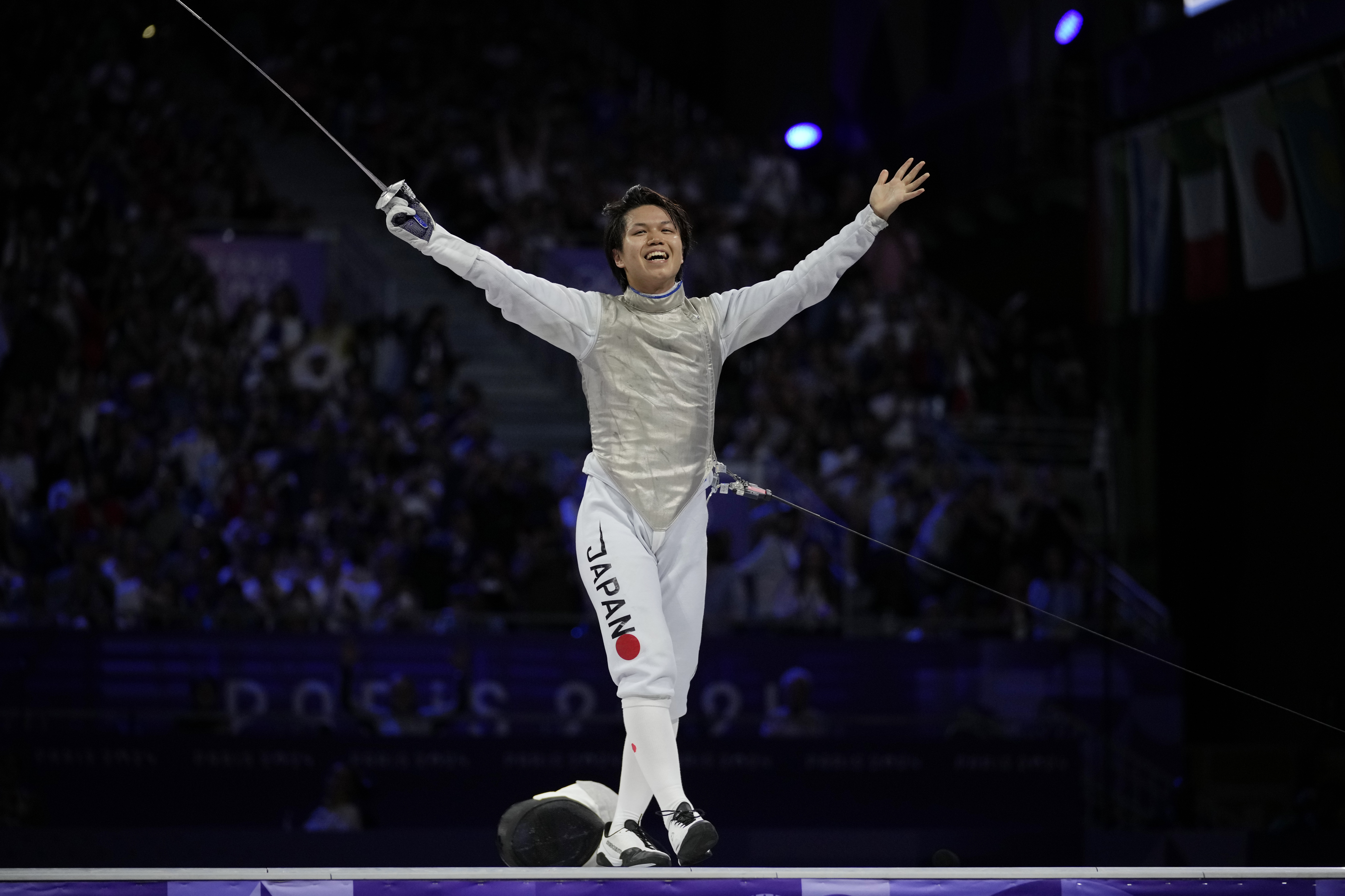 Japan's Kazuki Iimura celebrates after winning the men's team foil final match against Italy during the 2024 Summer Olympics at the Grand Palais, Sunday, Aug. 4, 2024, in Paris, France. 