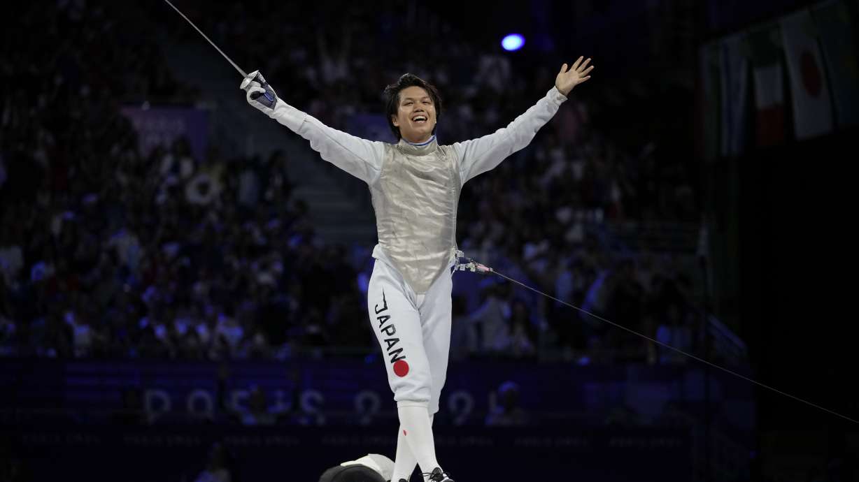 Japan's Kazuki Iimura celebrates after winning the men's team foil final match against Italy during the 2024 Summer Olympics at the Grand Palais, Sunday, Aug. 4, 2024, in Paris, France.
