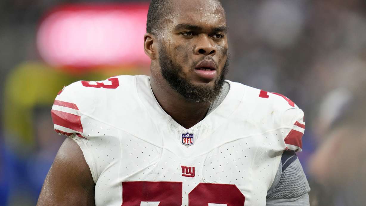 New York Giants offensive tackle Evan Neal (73) plays against the Las Vegas Raiders during an NFL football game Nov. 9, 2023, in Las Vegas. The third-year right tackle has not practice at training camp because he is still rehabilitating from ankle surgery in January 2024.