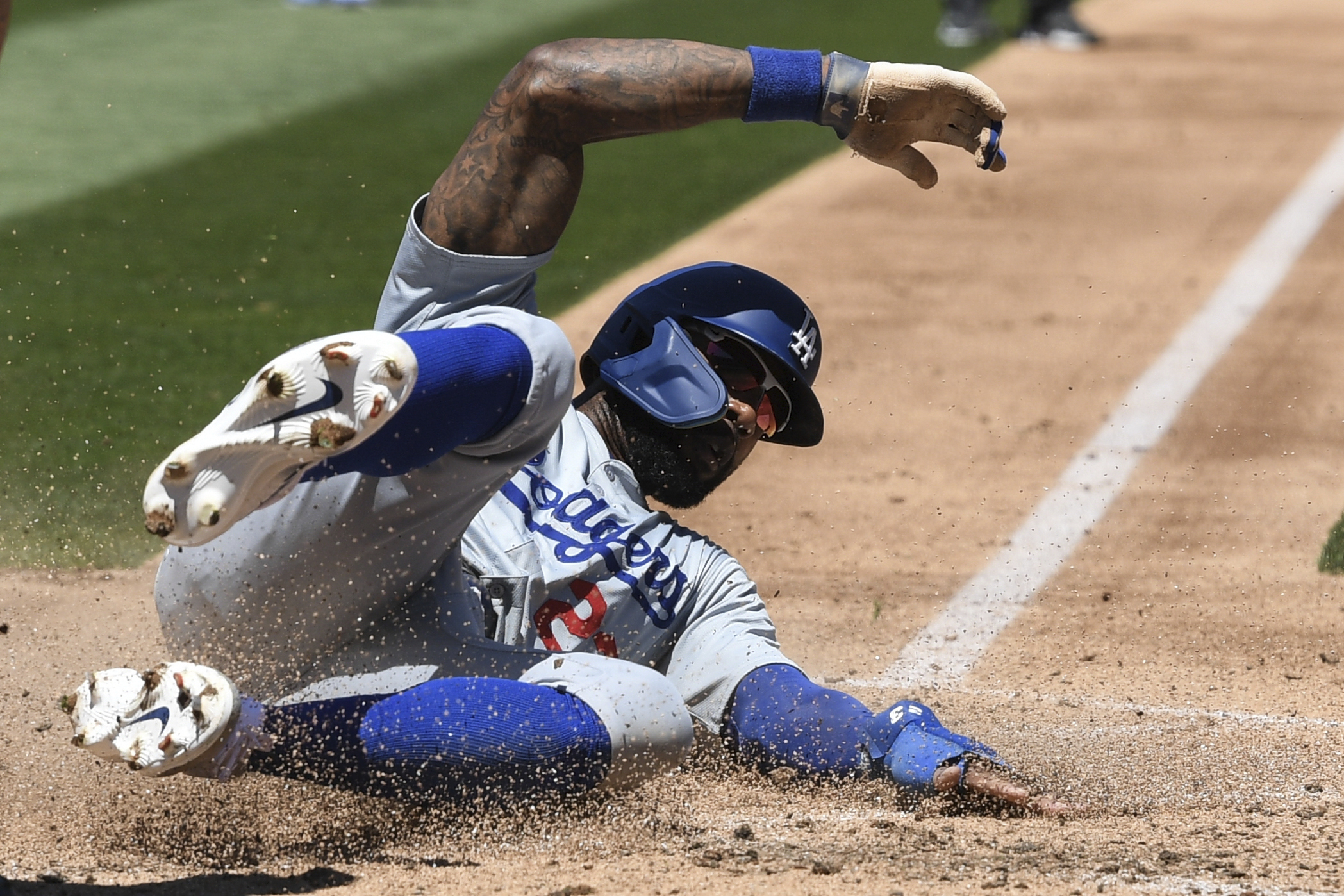 Los Angeles Dodgers' Jason Hayward slides home against the Oakland Athletics during the third inning of a baseball game Sunday, Aug. 4, 2024, in Oakland, Calif. 