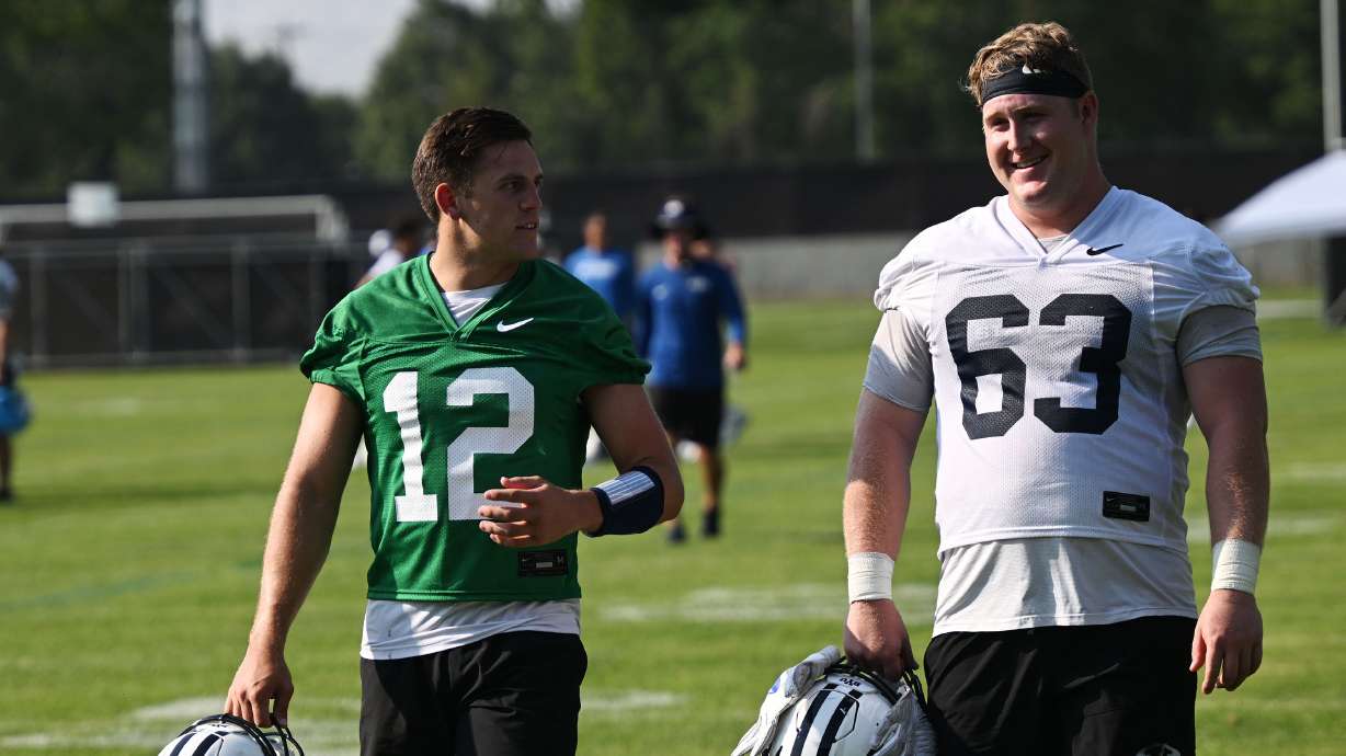 Quarterback Jake Retzlaff and offensive lineman Bruce Mitchell as they walk off the field as BYU holds their first fall football practice in Provo on Wednesday, July 31, 2024.