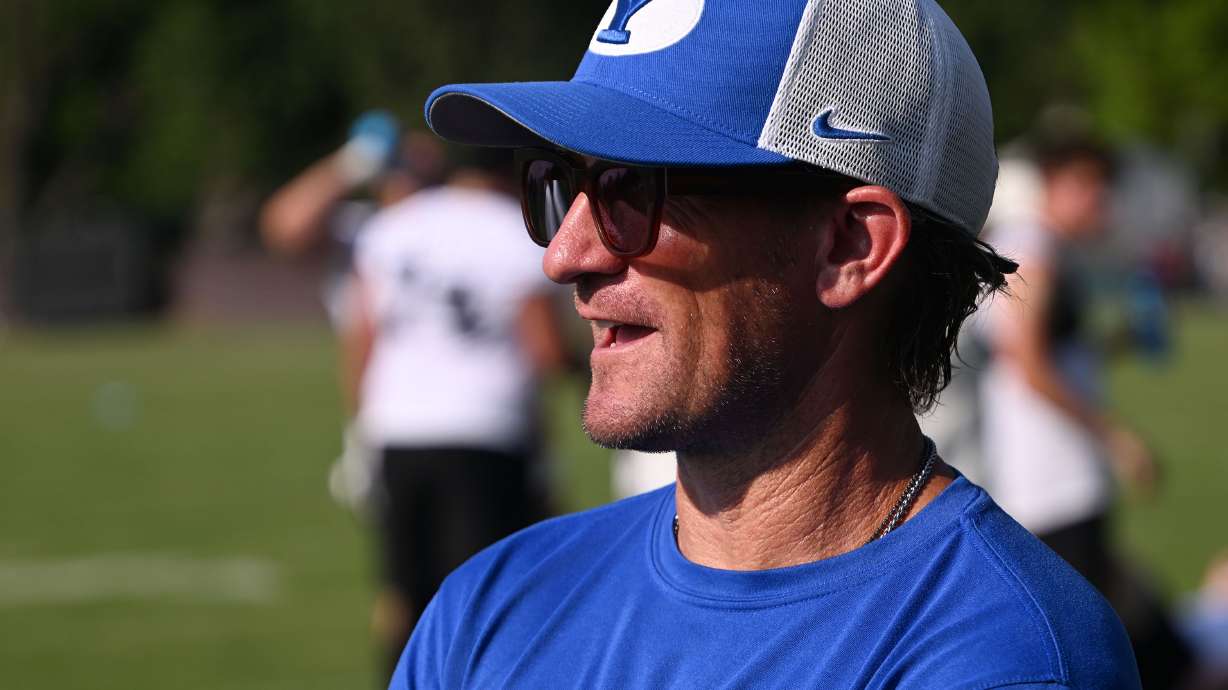 BYU offensive coordinator Aaron Roderick talks with defensive coordinator Jay Hill after BYU held their first fall football practice in Provo on Wednesday, July 31, 2024.