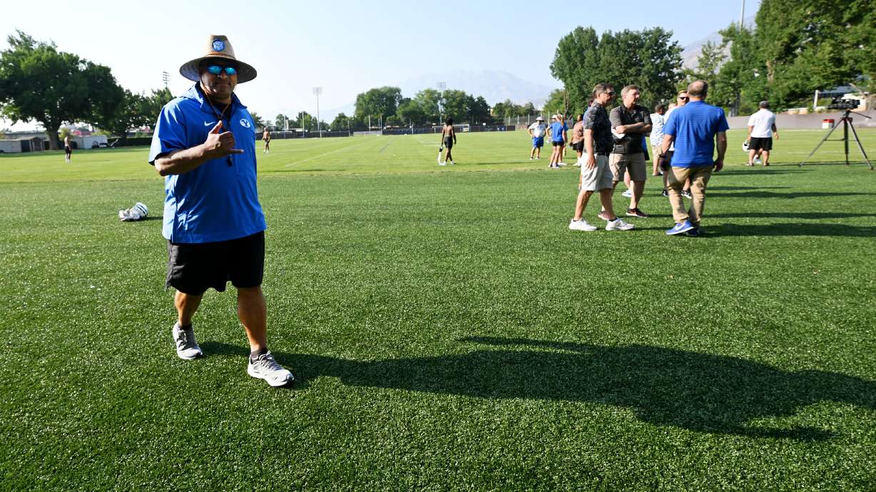 BYU head coach Kalani Sitake gives a shaka as he walks over to talk with media members after the Cougars held their first fall football practice in Provo on Wednesday, July 31, 2024.