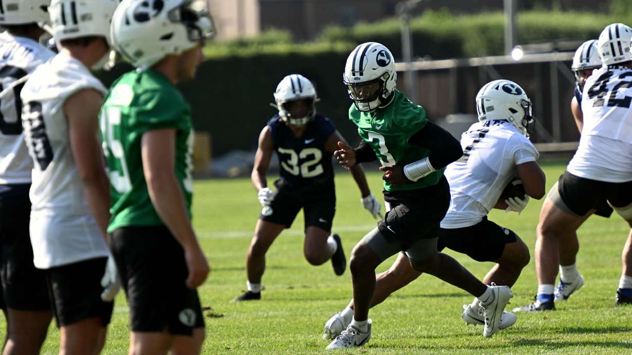 Quarterback Gerry Bohanon spins after handing off the ball as BYU holds their first fall football practice in Provo on Wednesday, July 31, 2024.