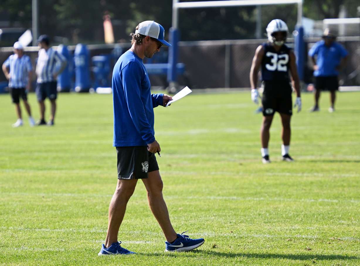 Offensive coordinator Aaron Roderick looks at his chart as BYU holds their first fall football practice in Provo on Wednesday, July 31, 2024.