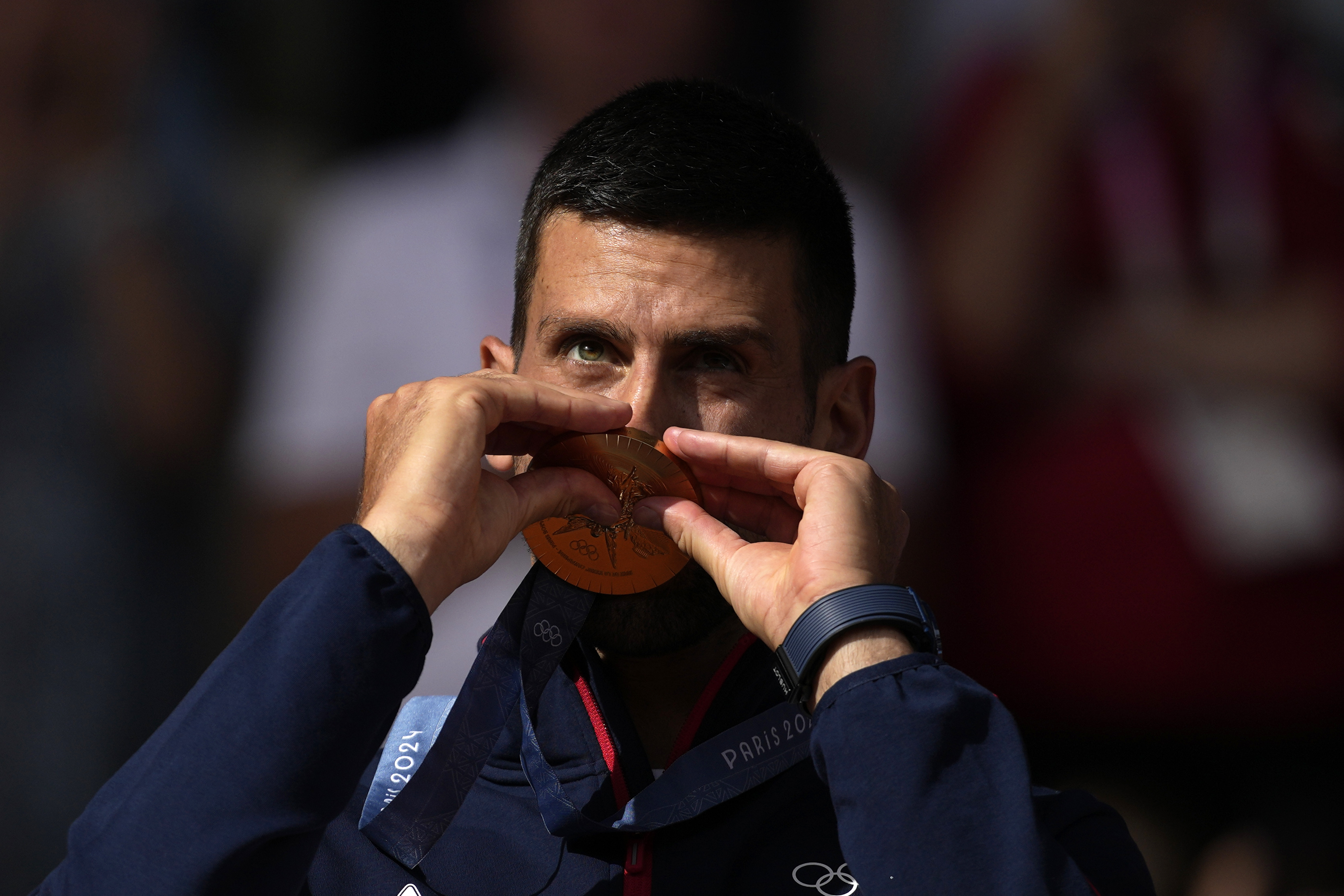 Serbia's Novak Djokovic kisses his gold medal after defeating Spain's Carlos Alcaraz during the men's singles tennis final at the Roland Garros stadium during the 2024 Summer Olympics, Sunday, Aug. 4, 2024, in Paris, France. Djokovic has won his first Olympic gold medal by beating Alcaraz 7-6 (3), 7-6 (2) in the 2024 Games men's tennis singles final. 