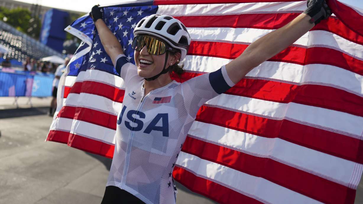 Kristen Faulkner, of the United States, celebrates winning the women's road cycling event, at the 2024 Summer Olympics, Sunday, Aug. 4, 2024, in Paris, France.