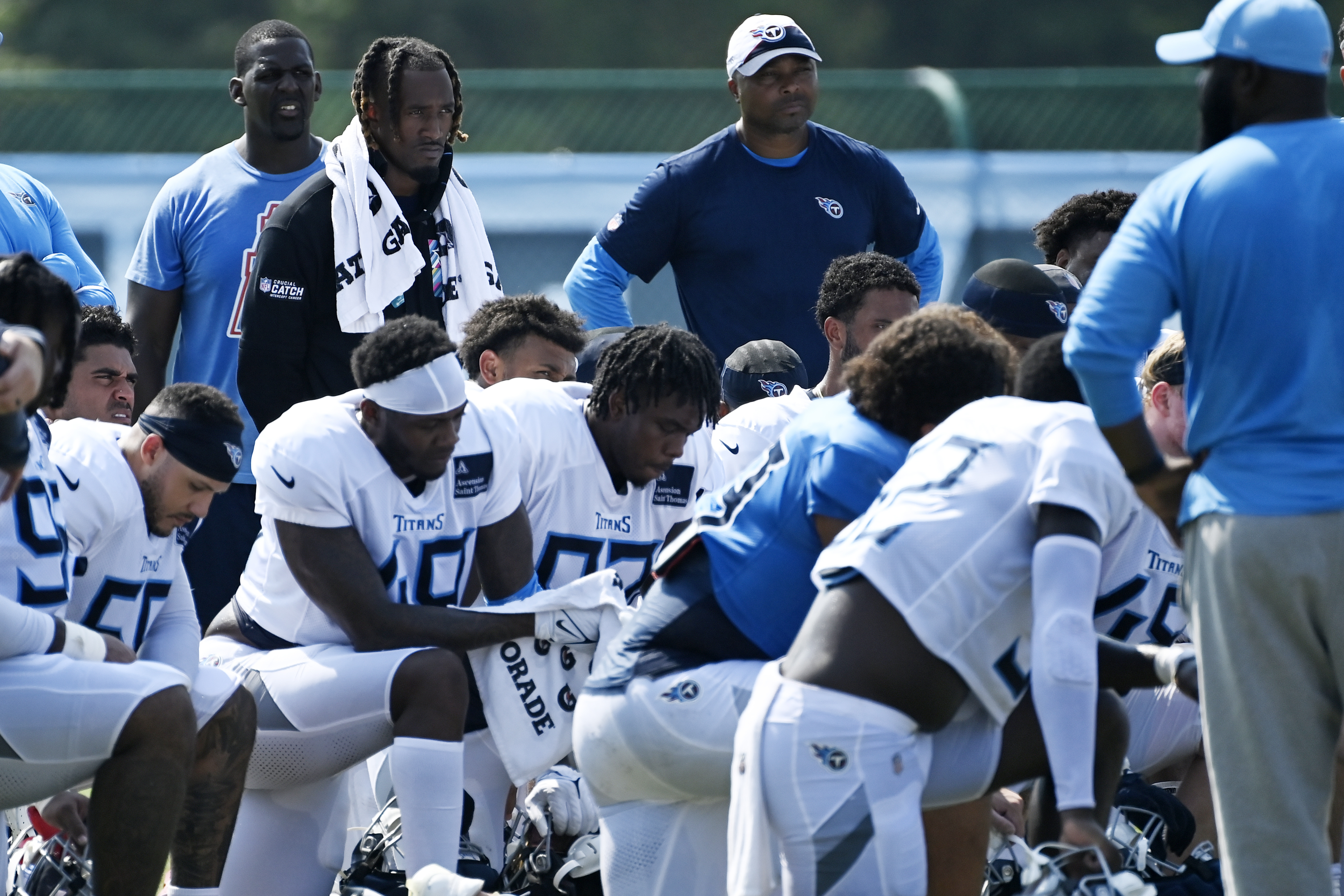 Tennessee Titans cornerback L'Jarius Sneed, top, second from left, listens to head coach Brian Callahan speak after an NFL football training camp practice Sunday, Aug. 4, 2024, in Nashville, Tenn. 