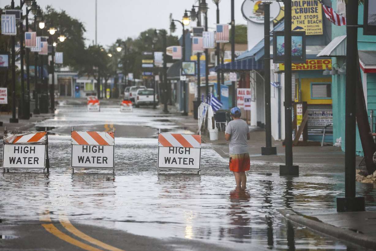 Flood water blocks a section of Dodecanese Blvd at the Tarpon Springs Sponge Docks, Monday morning, in Tarpon Springs, Fla., as Hurricane Debby passes the Tampa Bay area offshore.