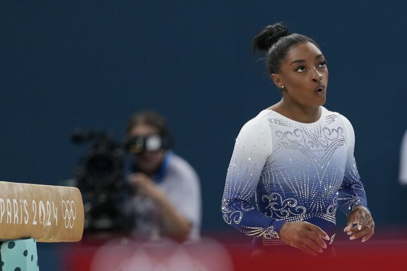 Simone Biles, of the United States, reacts after falling while competing during the women's artistic gymnastics individual balance beam finals at Bercy Arena at the 2024 Summer Olympics, Monday in Paris, France.