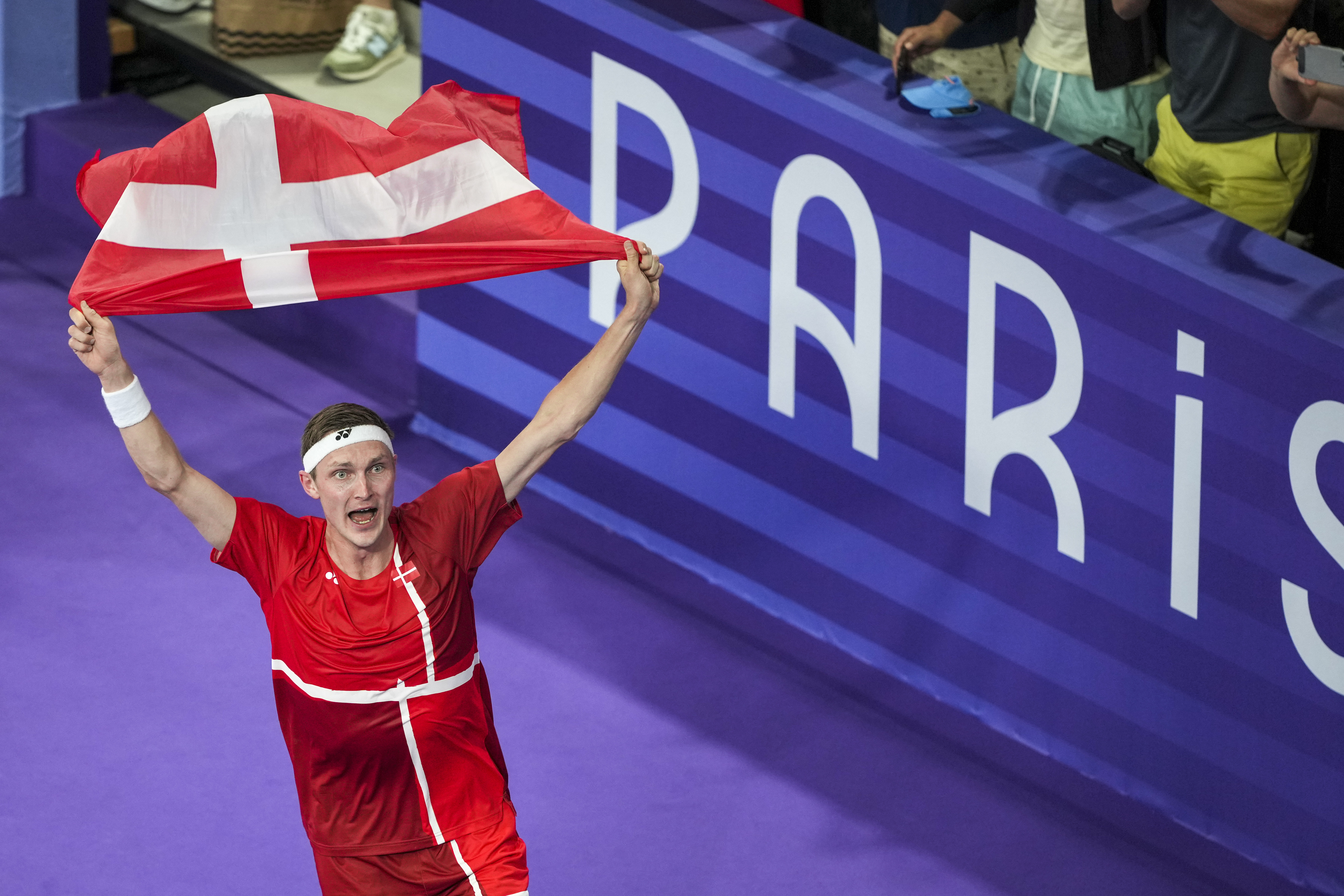 Denmark's Viktor Axelsen celebrates after defeating Thailand's Kunlavut Vitidsarn during their men's singles badminton gold medal match at the 2024 Summer Olympics, Monday, Aug. 5, 2024, in Paris, France. 