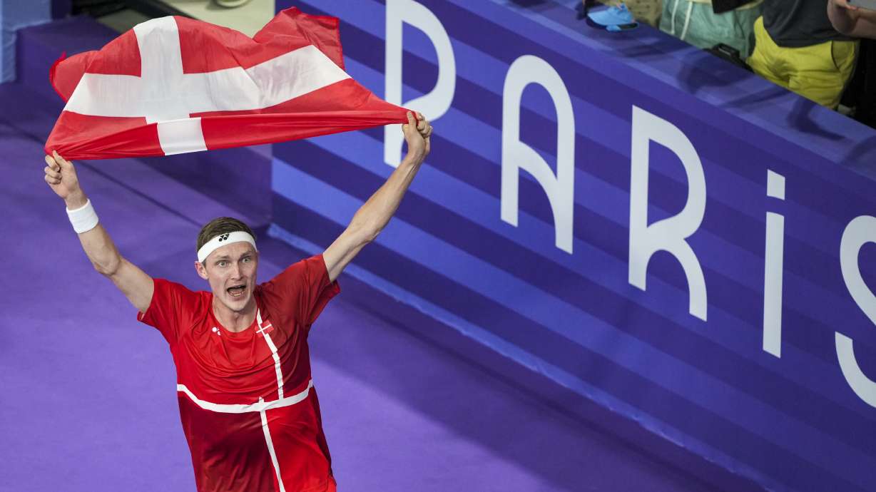 Denmark's Viktor Axelsen celebrates after defeating Thailand's Kunlavut Vitidsarn during their men's singles badminton gold medal match at the 2024 Summer Olympics, Monday, Aug. 5, 2024, in Paris, France.