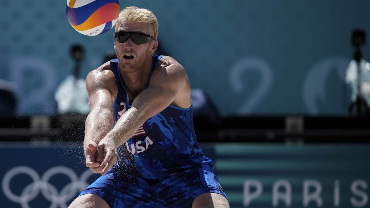 US' Chase Budinger hits the ball during the men's round of 16 beach volleyball match between USA and Norway at Eiffel Tower Stadium at the 2024 Summer Olympics, Monday, Aug. 5, 2024, in Paris, France.