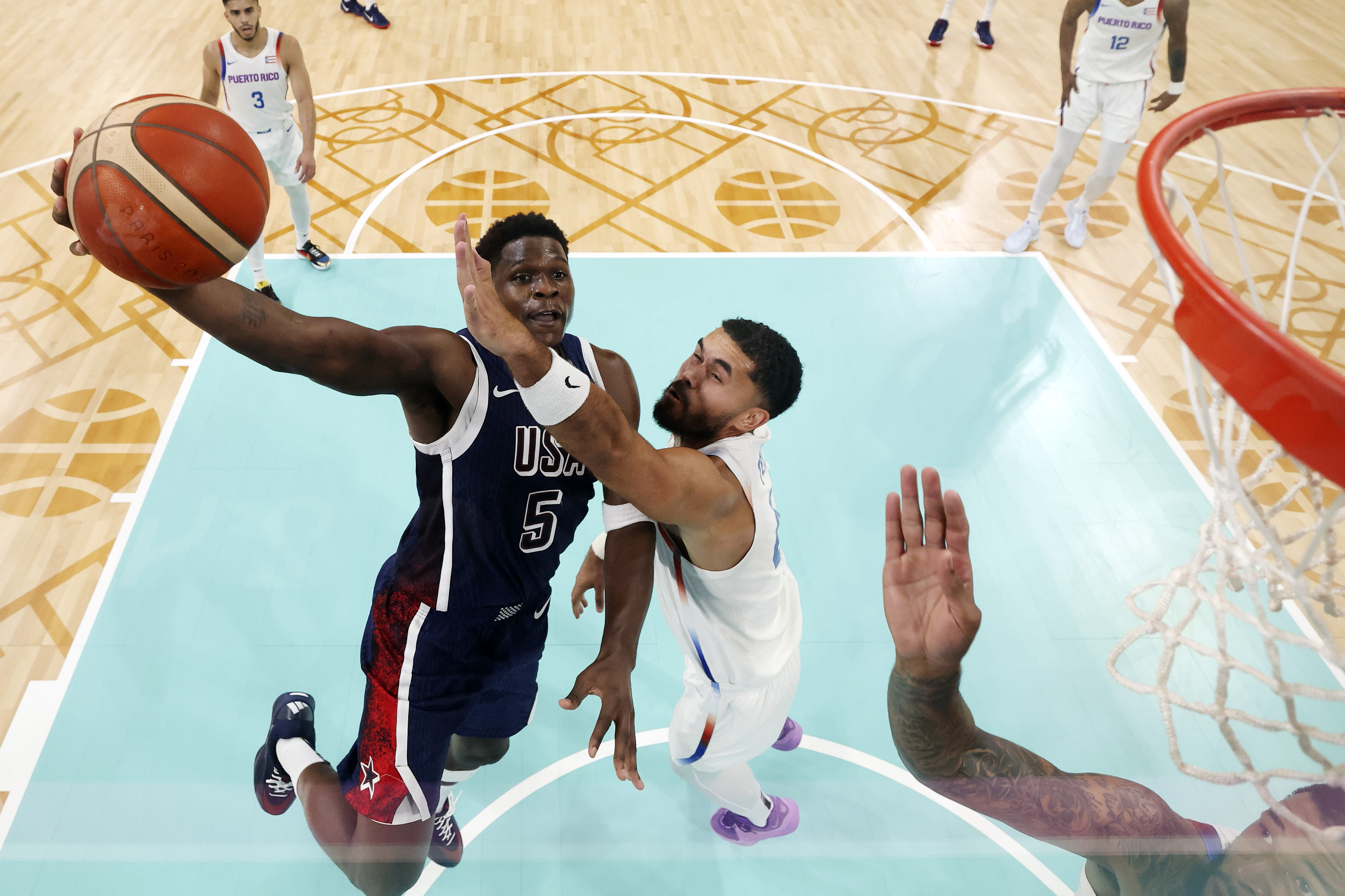 United States' Anthony Edwards, left, goes up for a shot as Puerto Rico's Arnaldo Toro defends at the 2024 Summer Olympics, Saturday, Aug. 3, 2024, in Villeneuve-d'Ascq, France. 