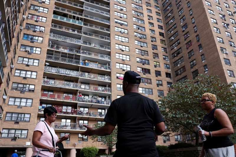 Anthony Gay converses with his neighbors about his struggle with air conditioning at 11 McKeever Place in New York City, July 26.