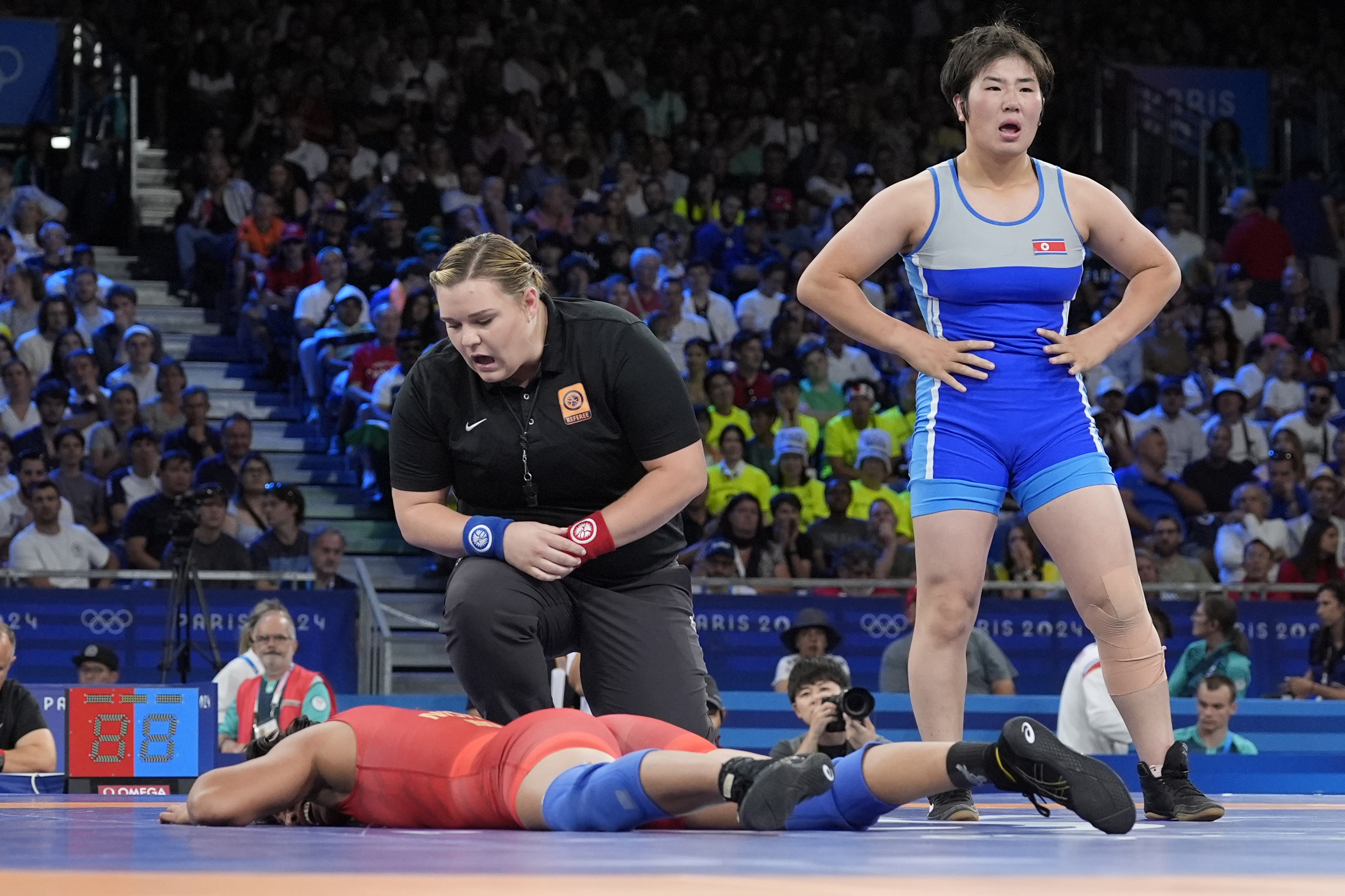 India's Nisha Nisha, bottom, reacts after the women's freestyle 68kg wrestling quarterfinal match against North Korea's Sol Gum Pak at Champ-de-Mars Arena, during the 2024 Summer Olympics, Monday, Aug. 5, 2024, in Paris, France. 