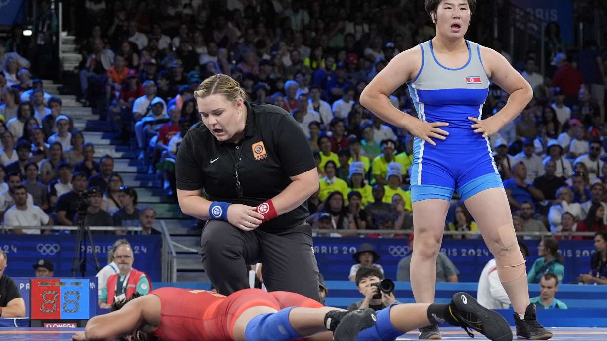 India's Nisha Nisha, bottom, reacts after the women's freestyle 68kg wrestling quarterfinal match against North Korea's Sol Gum Pak at Champ-de-Mars Arena, during the 2024 Summer Olympics, Monday, Aug. 5, 2024, in Paris, France.