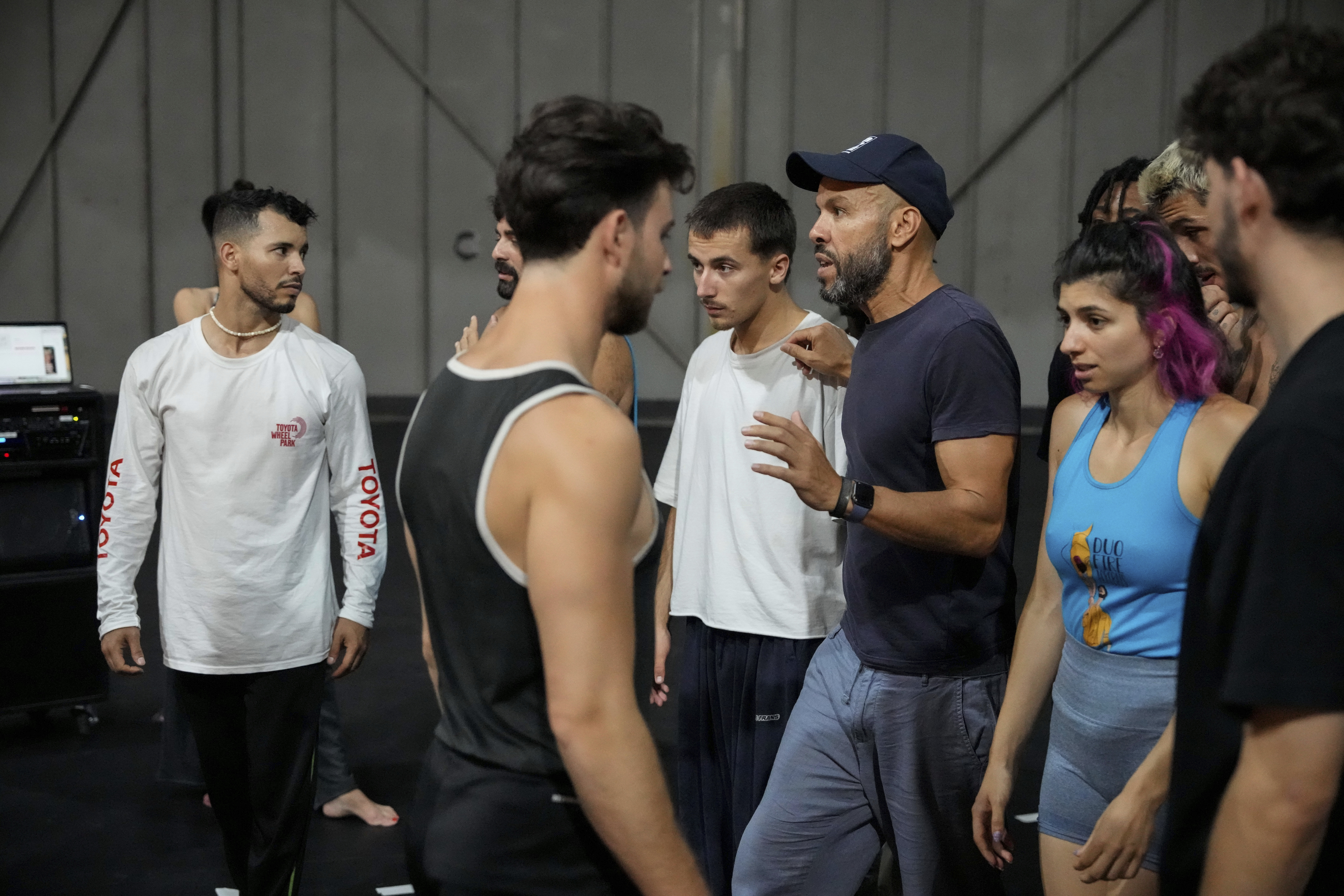 French-Algerian choreographer Mourad Merzouki guides his dancers as they rehearse for "Dance of the Games" at the concert hall in Creteil, east of Paris, Wednesday July 31, 2024. Merzouki is bringing hip-hop dance to the Paris Olympics. The French-Algerian choreographer is the creator of the “Dance of the Games.” Merzouki's showcase at the Trocadéro Champions Park kicks off Monday Aug. 5, 2024.