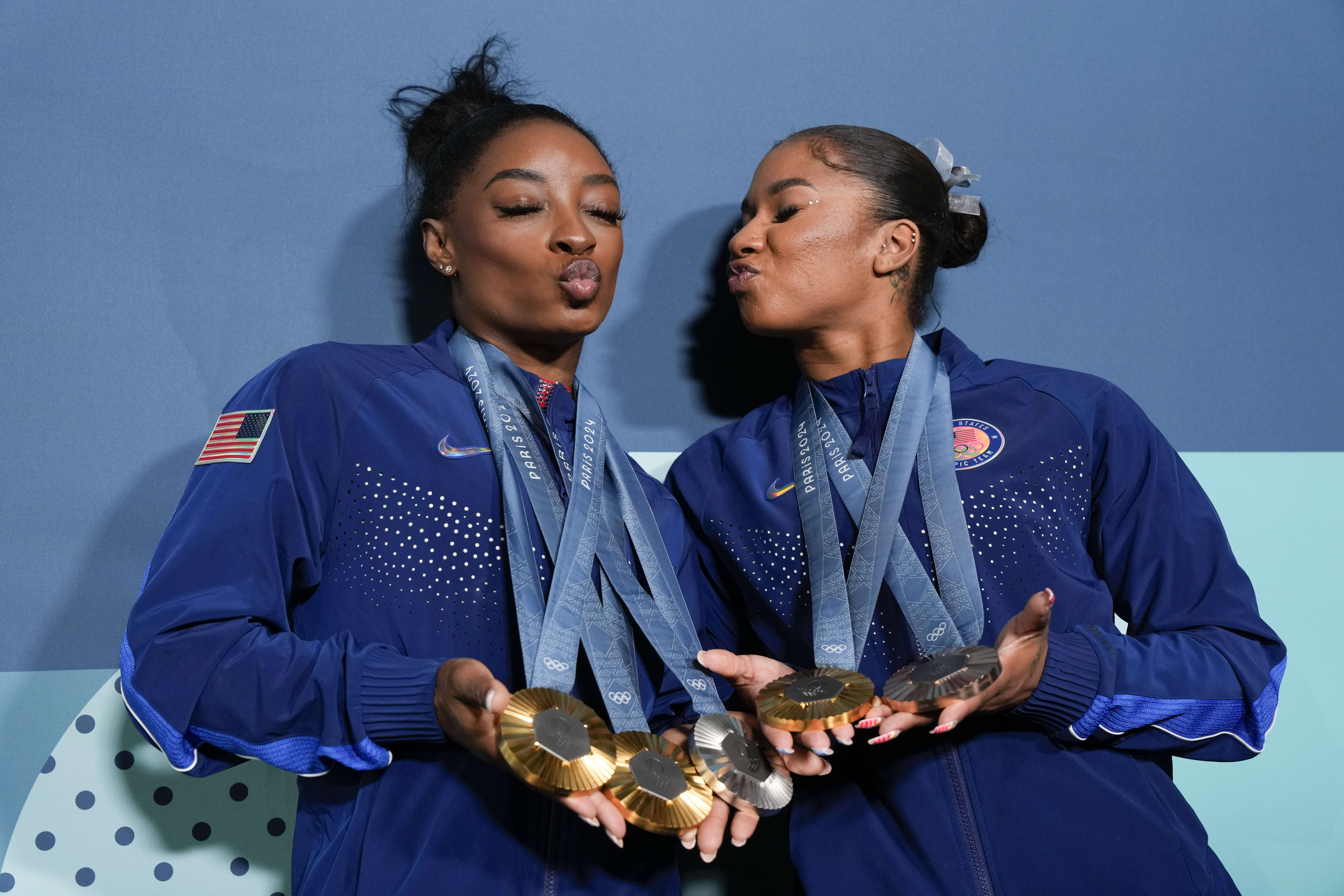 Jordan Chiles, of the United States, and Simone Biles, left, show off their medals after the women's artistic gymnastics individual apparatus finals Bercy Arena at the 2024 Summer Olympics, Monday, Aug. 5, 2024, in Paris, France. 