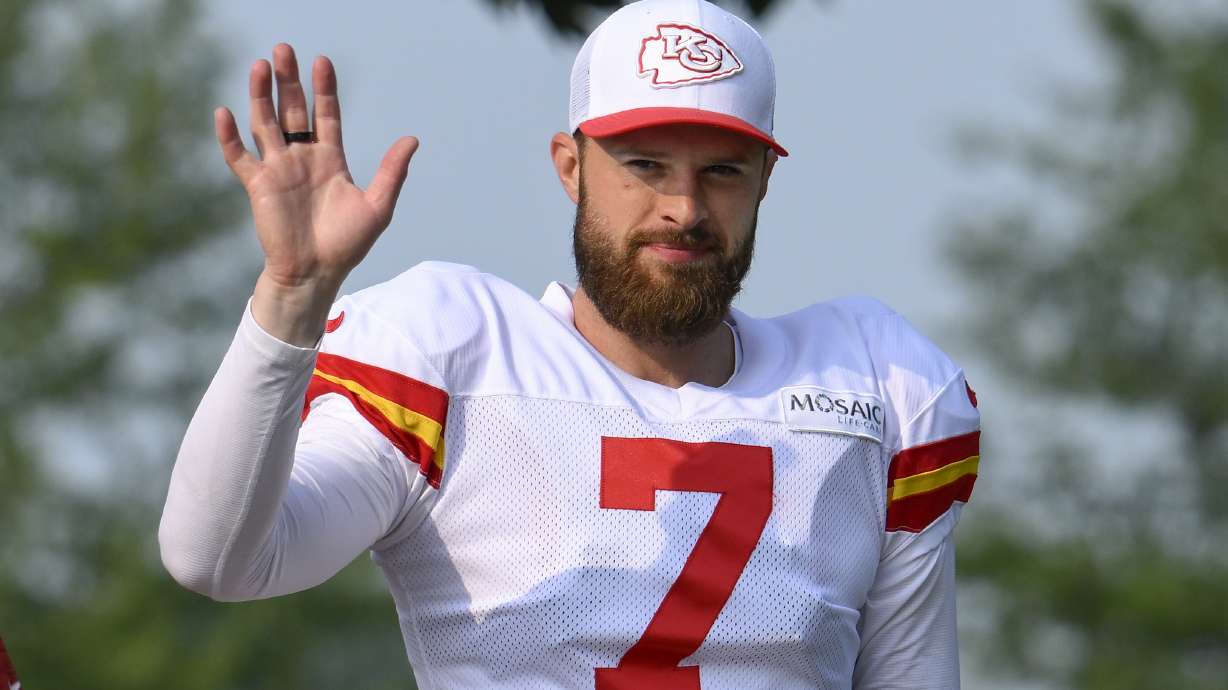 Kansas City Chiefs kicker Harrison Butker waves to the fans as he walks to the field at the start of an NFL football training camp Saturday, July 27, 2024, in St. Joseph, Mo.