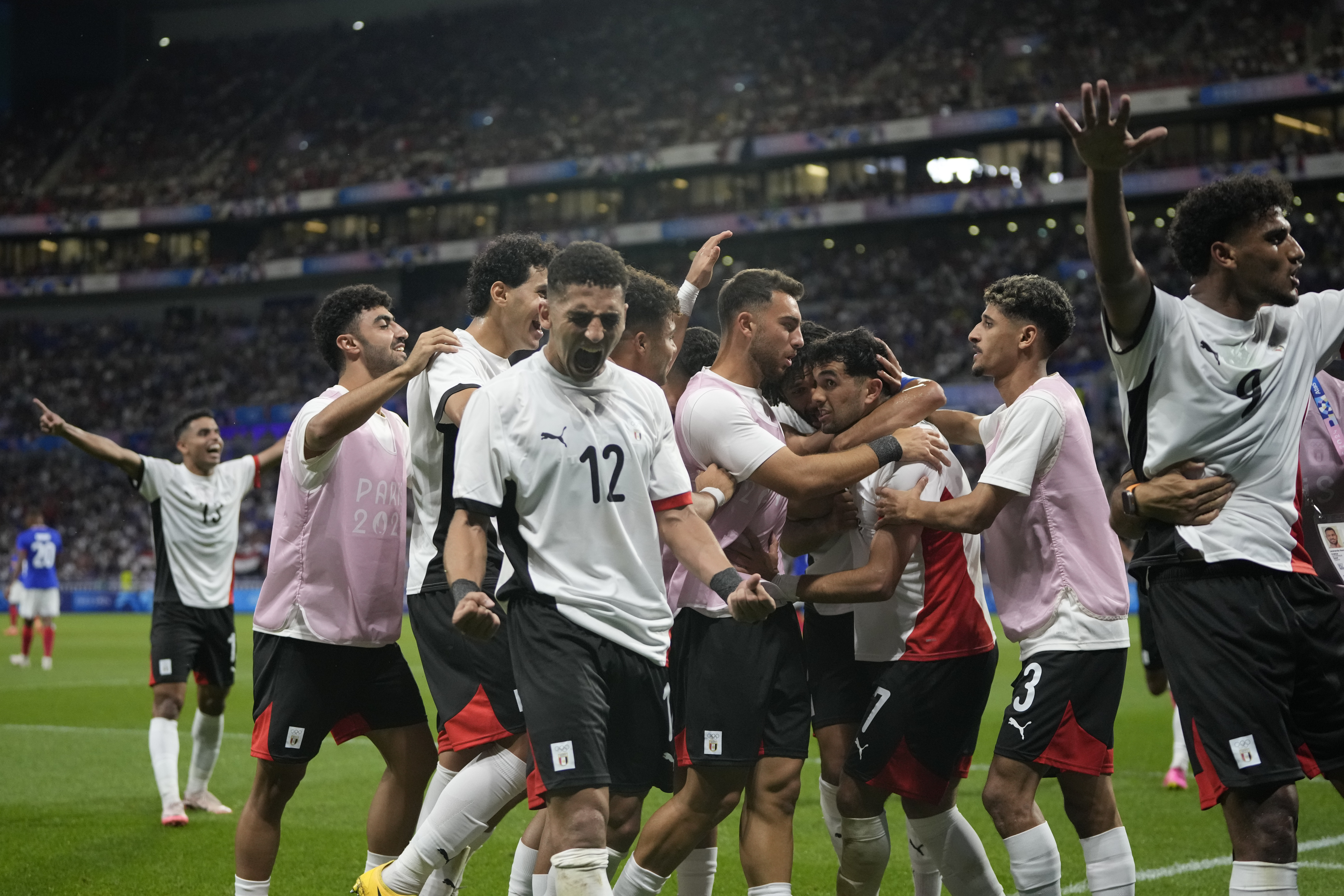 Egypt's players celebrate their side's opening goal scored by teammate Mahmoud Saber during the men's semifinal soccer match between France and Egypt, at Lyon Stadium, during the 2024 Summer Olympics, Monday, Aug. 5, 2024, in Decines, France. 
