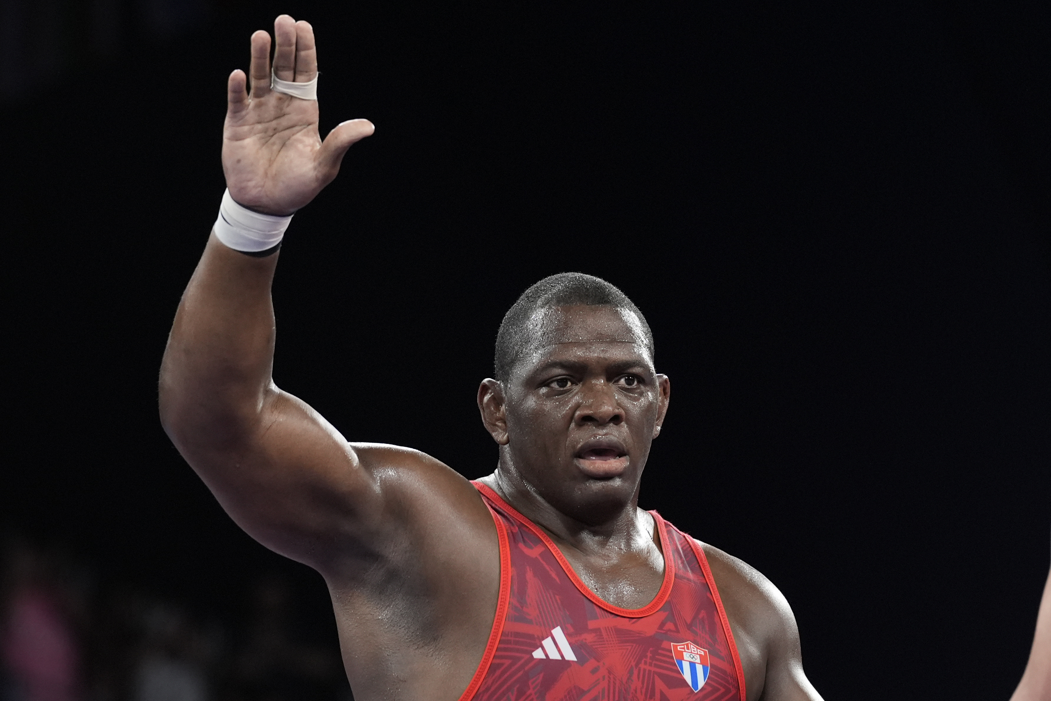 Cuba's Mijain Lopez celebrates after defeating Azerbaijan's Sabah Shariati during their men's Greco-Roman 130kg wrestling semifinal match, at Champ-de-Mars Arena, during the 2024 Summer Olympics, Monday, Aug. 5, 2024, in Paris, France. 