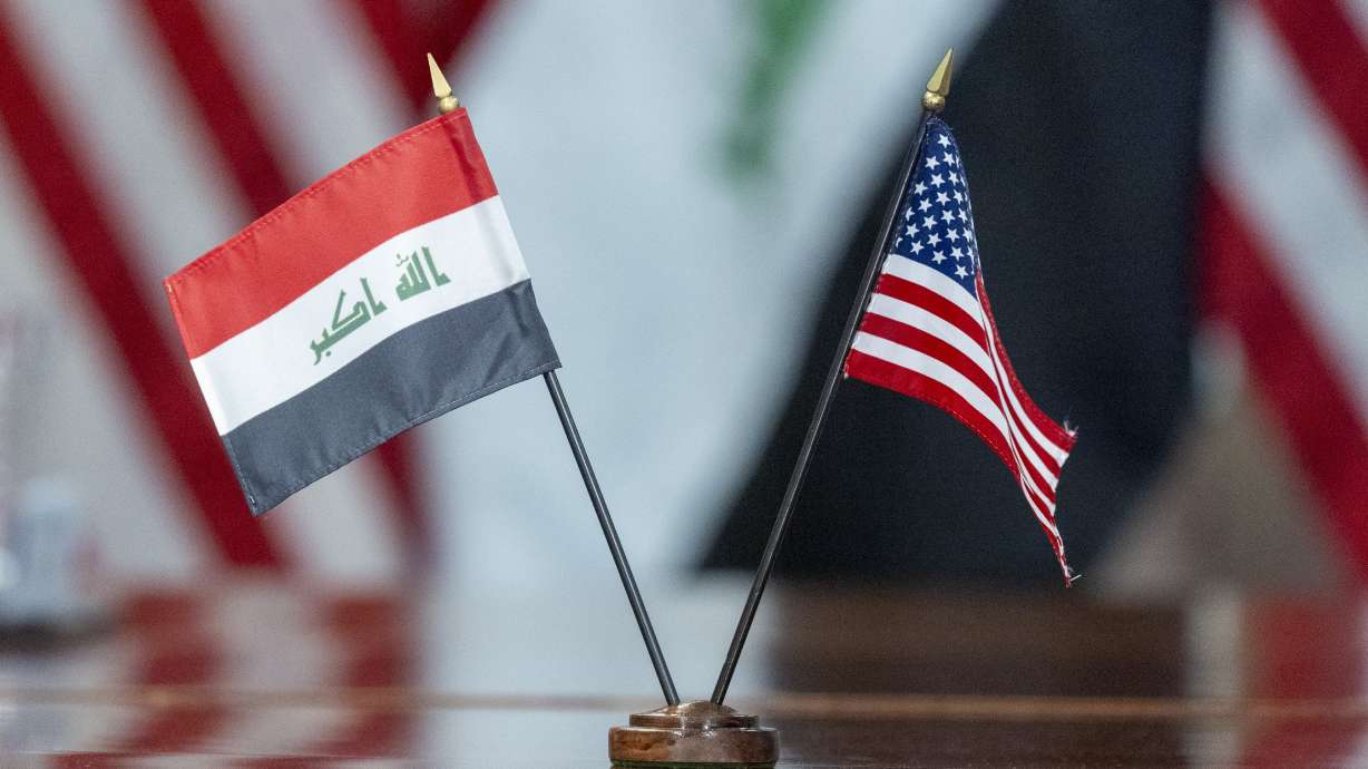 The flags of Iraq and the United States are placed on the table during a meeting with Secretary of Defense Lloyd Austin meets and Iraqi Defense Minister Muhammad Al-Abbasi at the Pentagon, July 23, in Washington. Defense officials say several U.S. personnel were injured in a suspected rocket attack at a military base in Iraq.