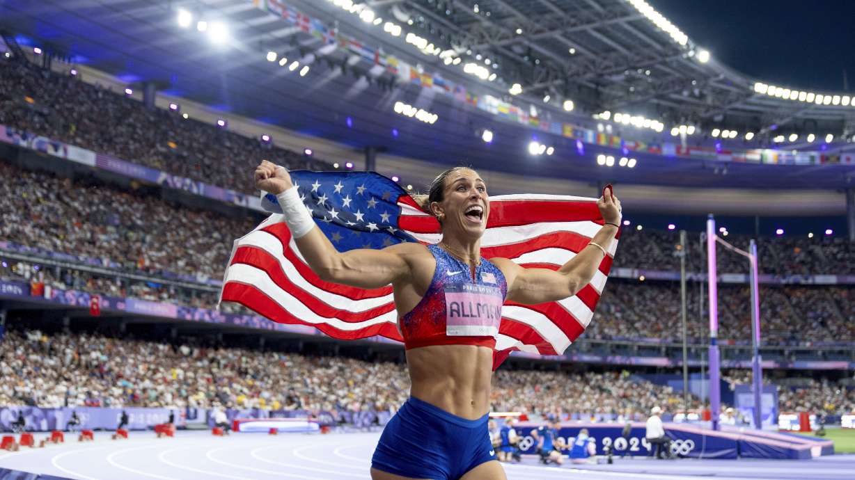 The United States' Valarie Allman takes a victory lap after winning the women's discus throw at the 2024 Summer Olympics, Monday, Aug. 5, 2024, in Saint-Denis, France.