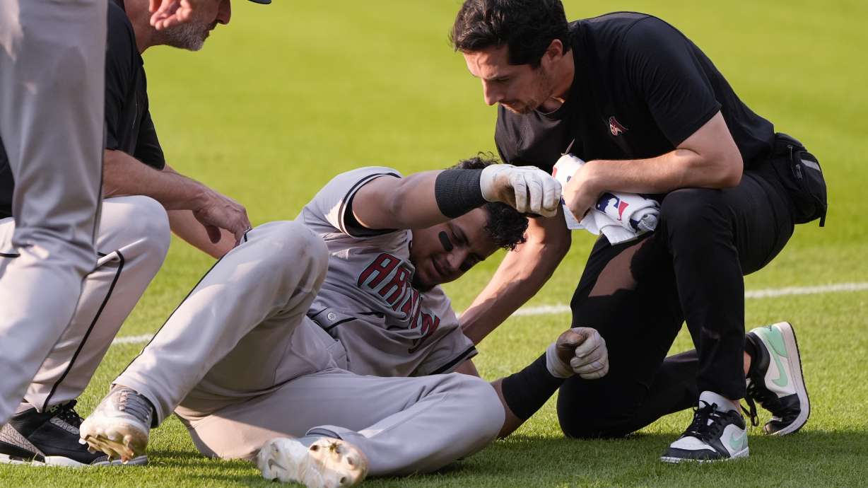 Arizona Diamondbacks' Gabriel Moreno is helped up after an injury in the second inning of a baseball game against the Cleveland Guardians in Cleveland, Monday, Aug. 5, 2024.