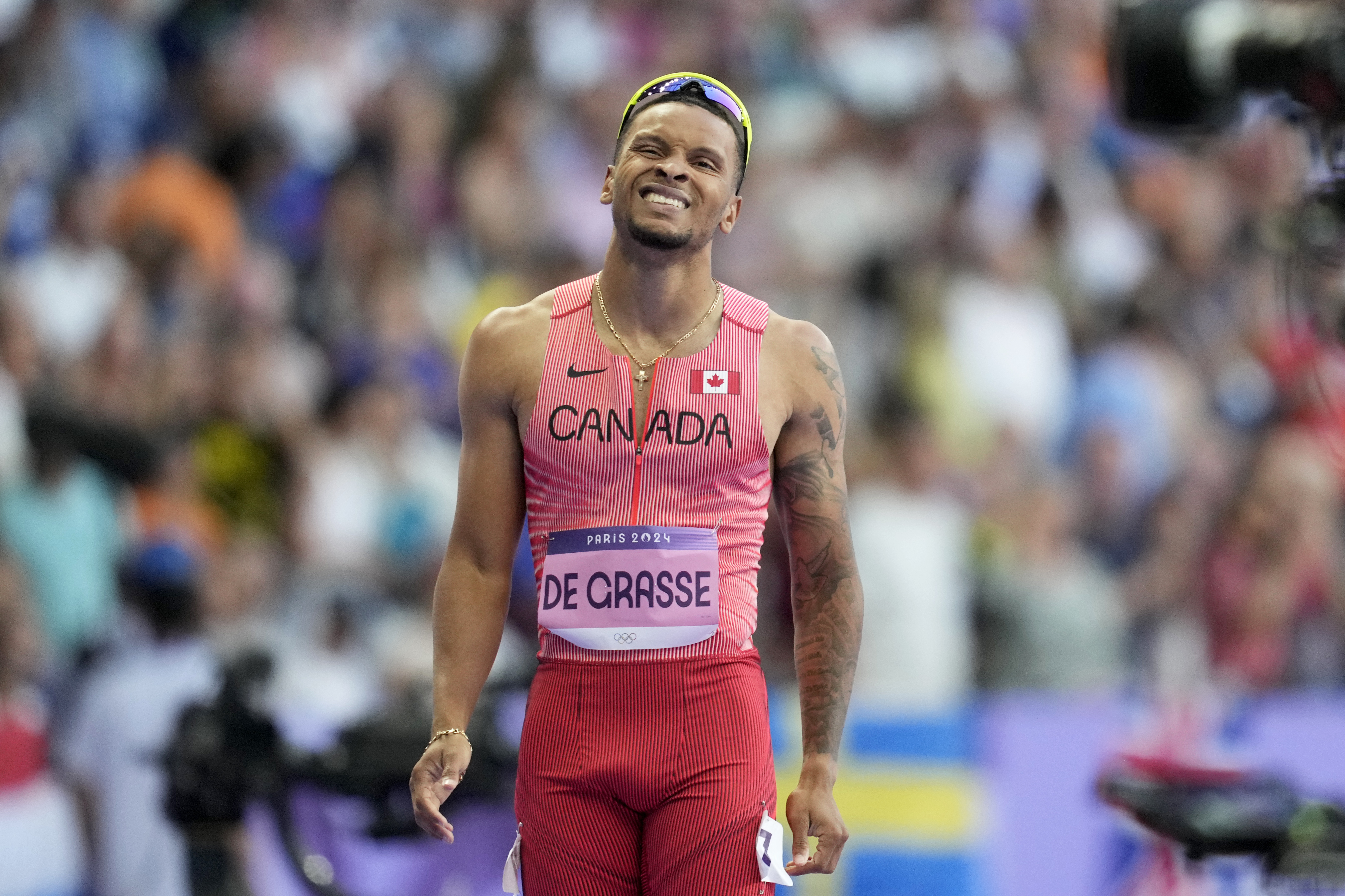 Andre de Grasse, of Canada, reacts after crossing the finish line in a men's 200 meters round 1 heat at the 2024 Summer Olympics, Monday, Aug. 5, 2024, in Saint-Denis, France. 