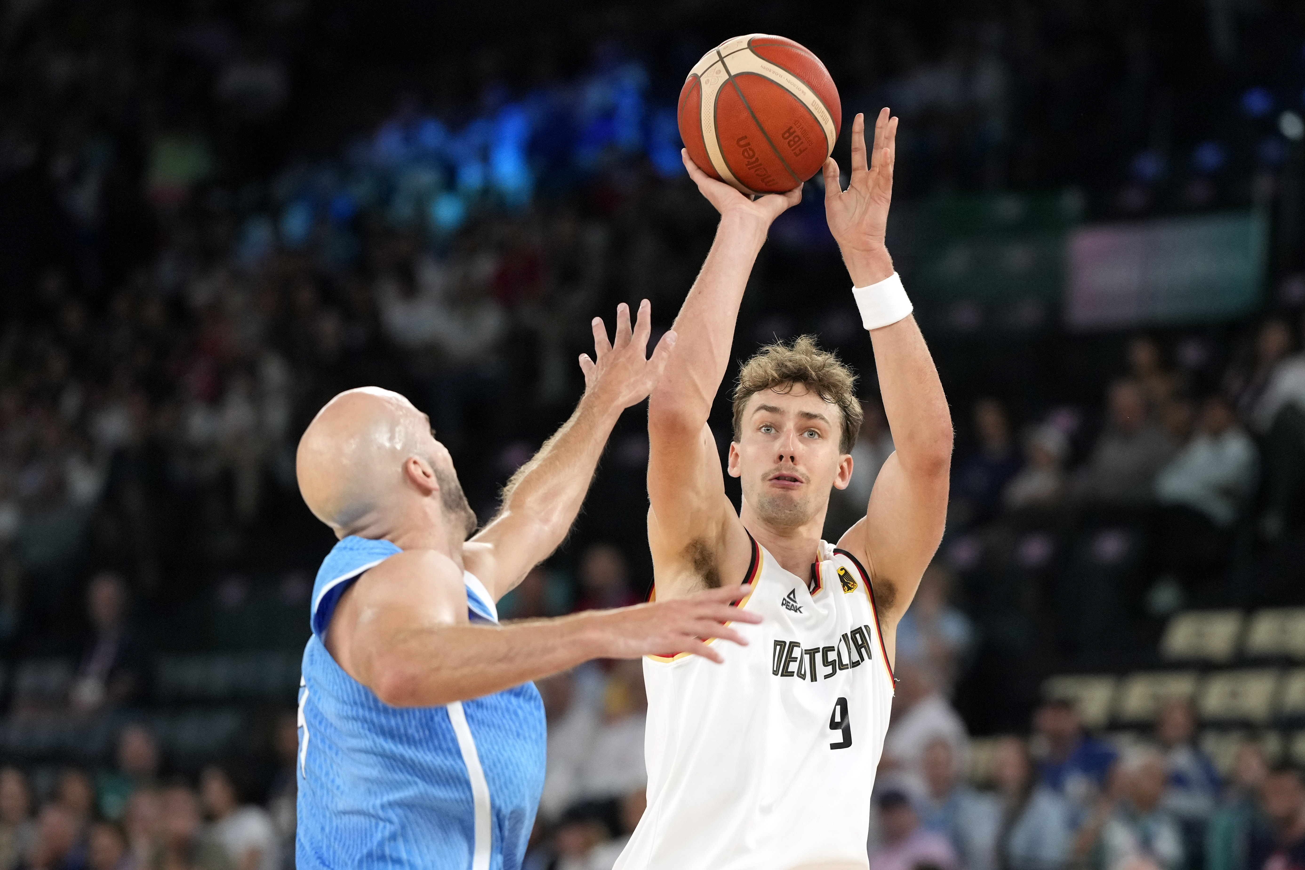 Franz Wagner, right, of Germany, shoots as Nick Calathes, of Greece, defends during a men's basketball game at the 2024 Summer Olympics, Tuesday, Aug. 6, 2024, in Villeneuve-d'Ascq, France.
