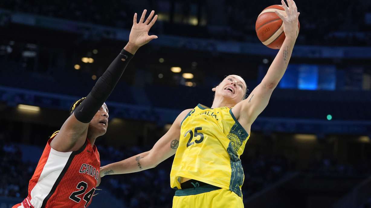 Australia's Lauren Jackson, right, reached for a rebound along with Canada's Aaliyah Edwards during a women's basketball game at the 2024 Summer Olympics, Thursday, Aug. 1, 2024, in Villeneuve-d'Ascq, France.