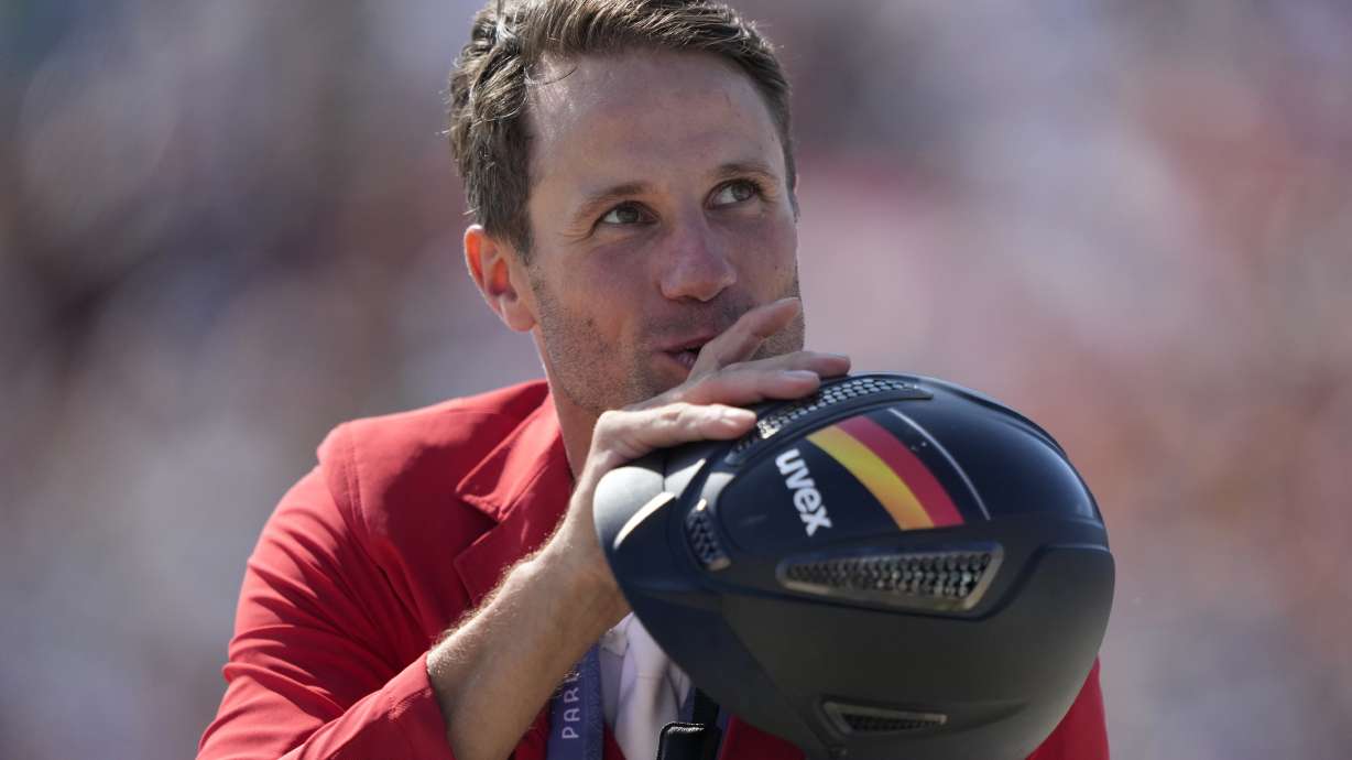Germany's Christian Kukuk wearing his gold medal rides Checker 47 after the Jumping Individual final at the 2024 Summer Olympics, Tuesday, Aug. 6, 2024, in Versailles, France.