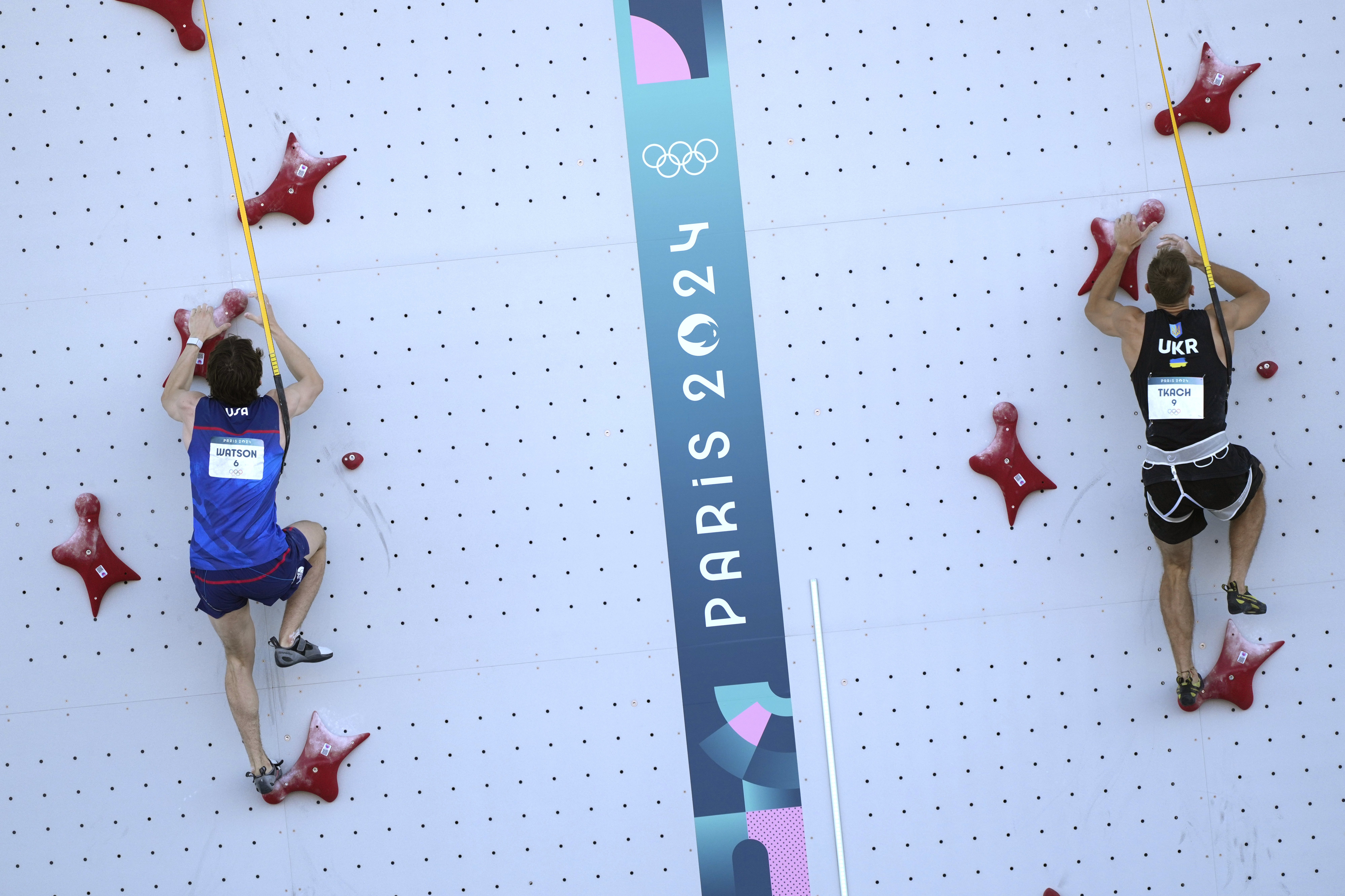 Sam Watson of the United States, left, and Yaroslav Tkach of Ukraine compete in the men's speed, qualification seeding, during the sport climbing competition at the 2024 Summer Olympics, Tuesday, Aug. 6, 2024, in Le Bourget, France. 