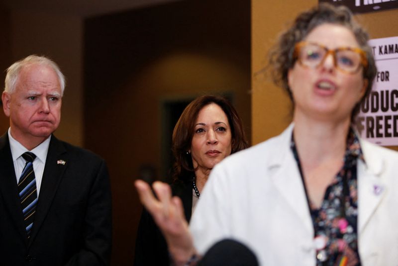 Vice President Kamala Harris and Minnesota Gov. Tim Walz listen to Dr. Sarah Traxler as Harris visits the St. Paul Health Center, a clinic that performs abortions, in St. Paul, Minnesota, U.S., March 14. Harris picked Walz as her running mate Tuesday.