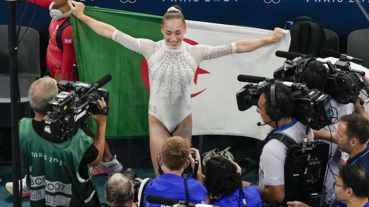 Kaylia Nemour, of Algeria, reacts after winning the gold medal during the women's artistic gymnastics individual uneven bars finals in Bercy Arena at the 2024 Summer Olympics, Sunday, Aug. 4, 2024, in Paris, France.