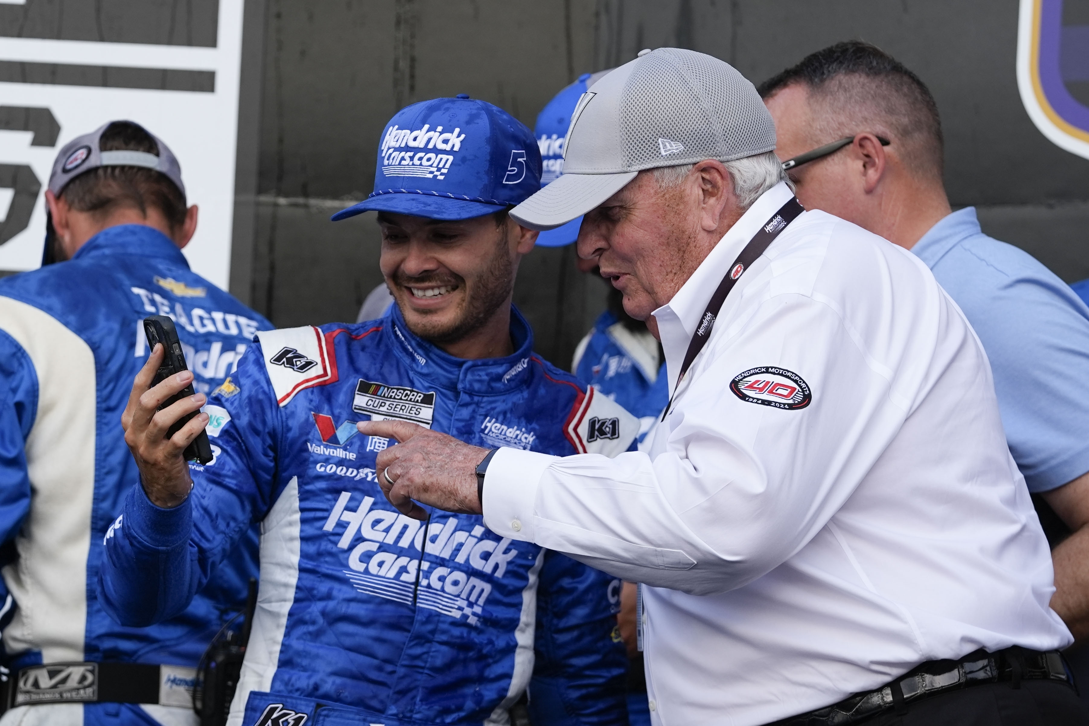 Kyle Larson, front left, walks with Rick Hendric, front right, after Larson won a NASCAR Cup Series auto race at Indianapolis Motor Speedway, Sunday, July 21, 2024, in Indianapolis. 