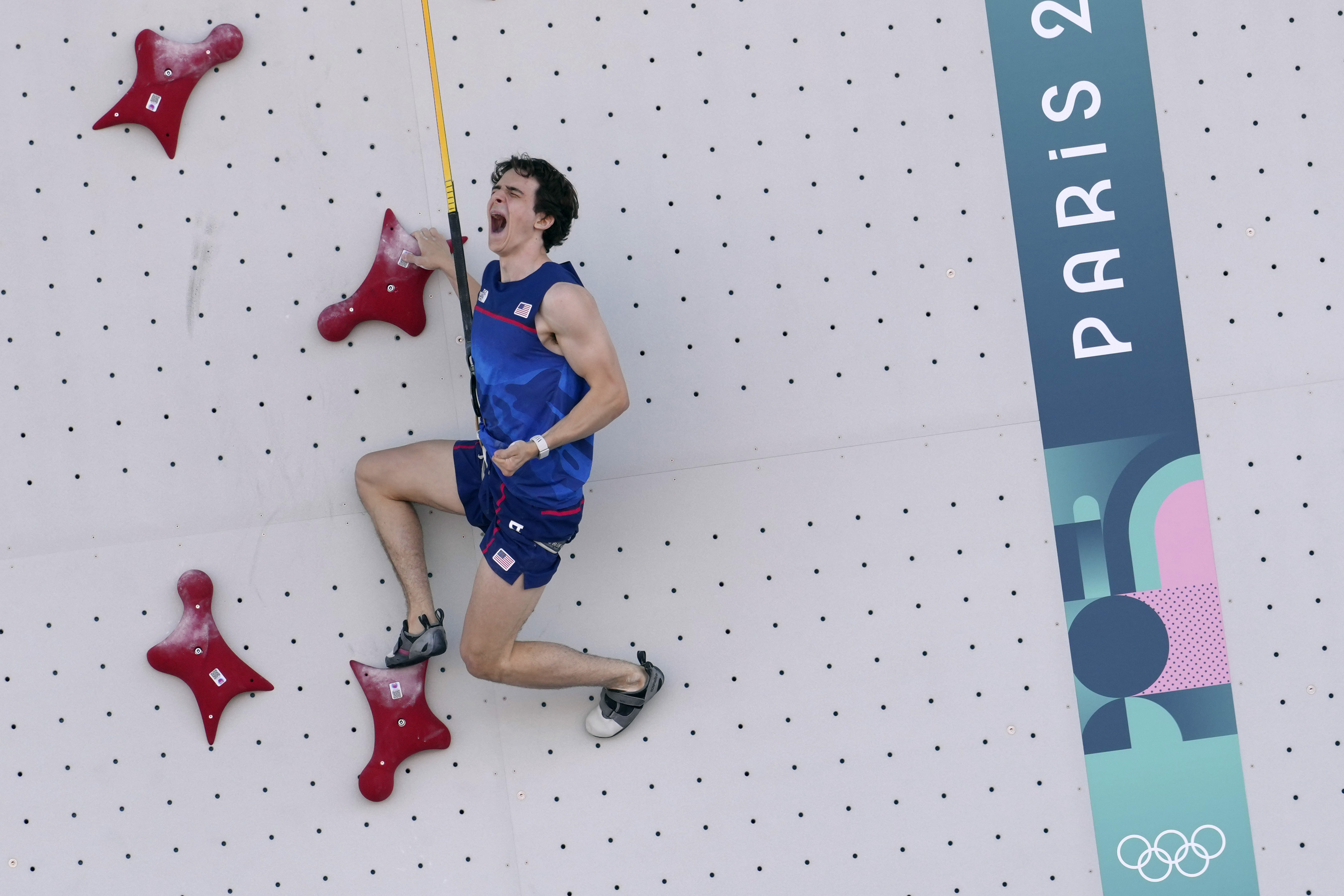 Sam Watson of the United States reacts as he competes in the men's speed, qualification elimination heats, during the sport climbing competition at the 2024 Summer Olympics, Tuesday, Aug. 6, 2024, in Le Bourget, France.