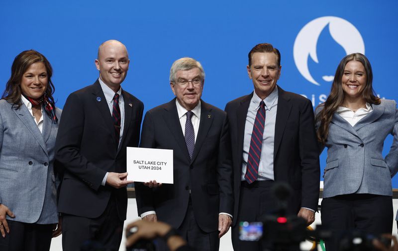 International Olympic Committee President Thomas Bach stands with Utah Gov. Spencer Cox and Fraser Bullock, president and CEO of the Salt Lake City-Utah Committee July 24. Committee says double awarding of the Games brings stability to the Olympic movement.