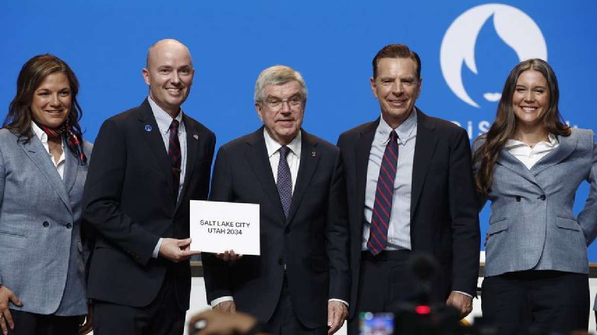 International Olympic Committee President Thomas Bach stands with Utah Gov. Spencer Cox and Fraser Bullock, president and CEO of the Salt Lake City-Utah Committee July 24. Committee says double awarding of the Games brings stability to the Olympic movement.