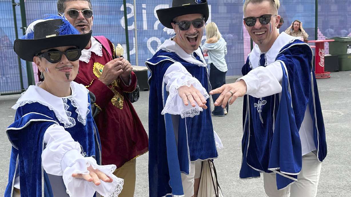 From left, Parisians Mathilde Joannard and Franck Tallieu pose with friends Jakub Mroz and Pawel Czechowicz while taking a break during the fencing competition at the 2024 Summer Olympics at the Grand Palais in Paris, France, Saturday, Aug. 3, 2024.