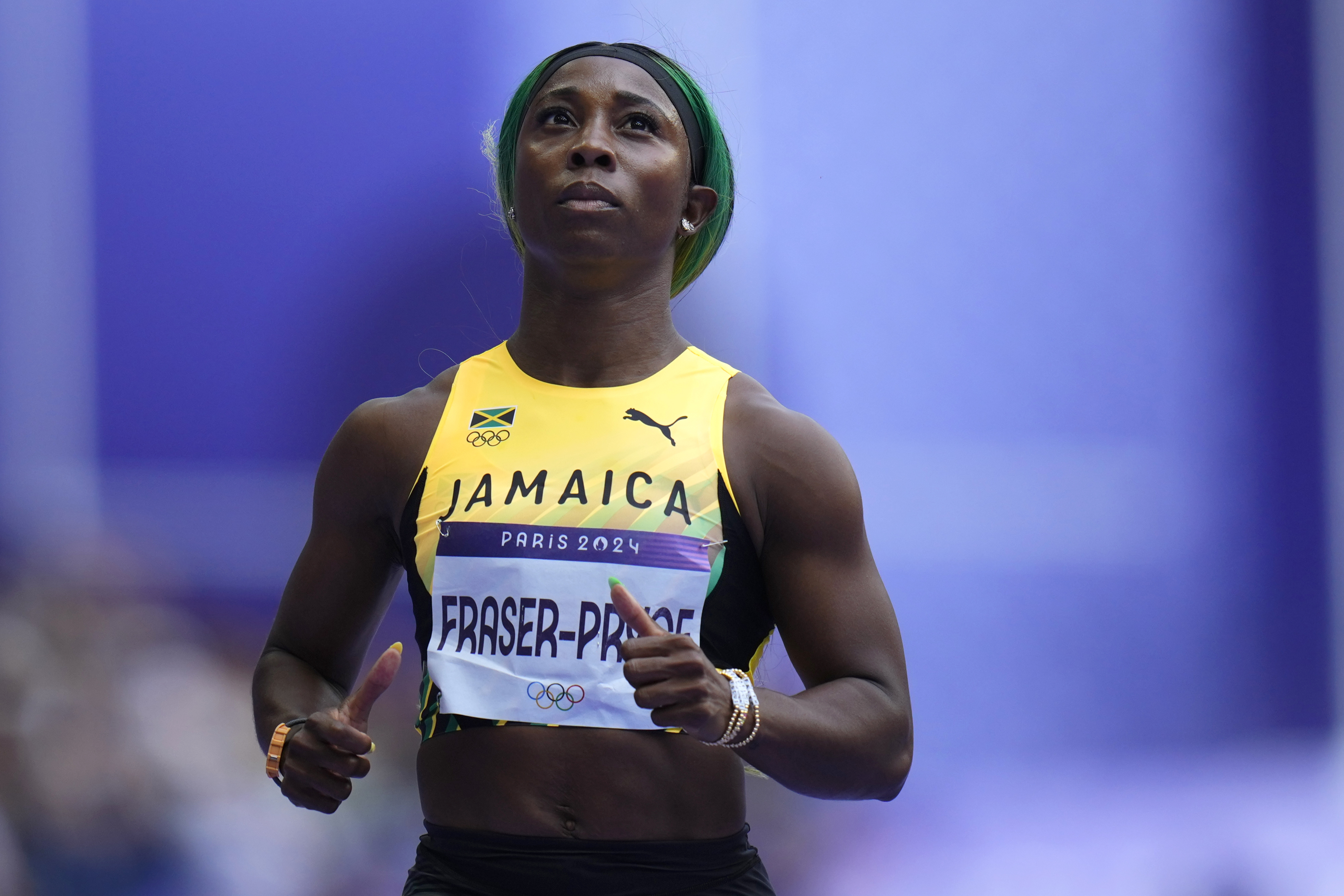 Shelly-Ann Fraser-Pryce, of Jamaica, runs in a women's 100-meter heat at the 2024 Summer Olympics, Friday, Aug. 2, 2024, in Saint-Denis, France.