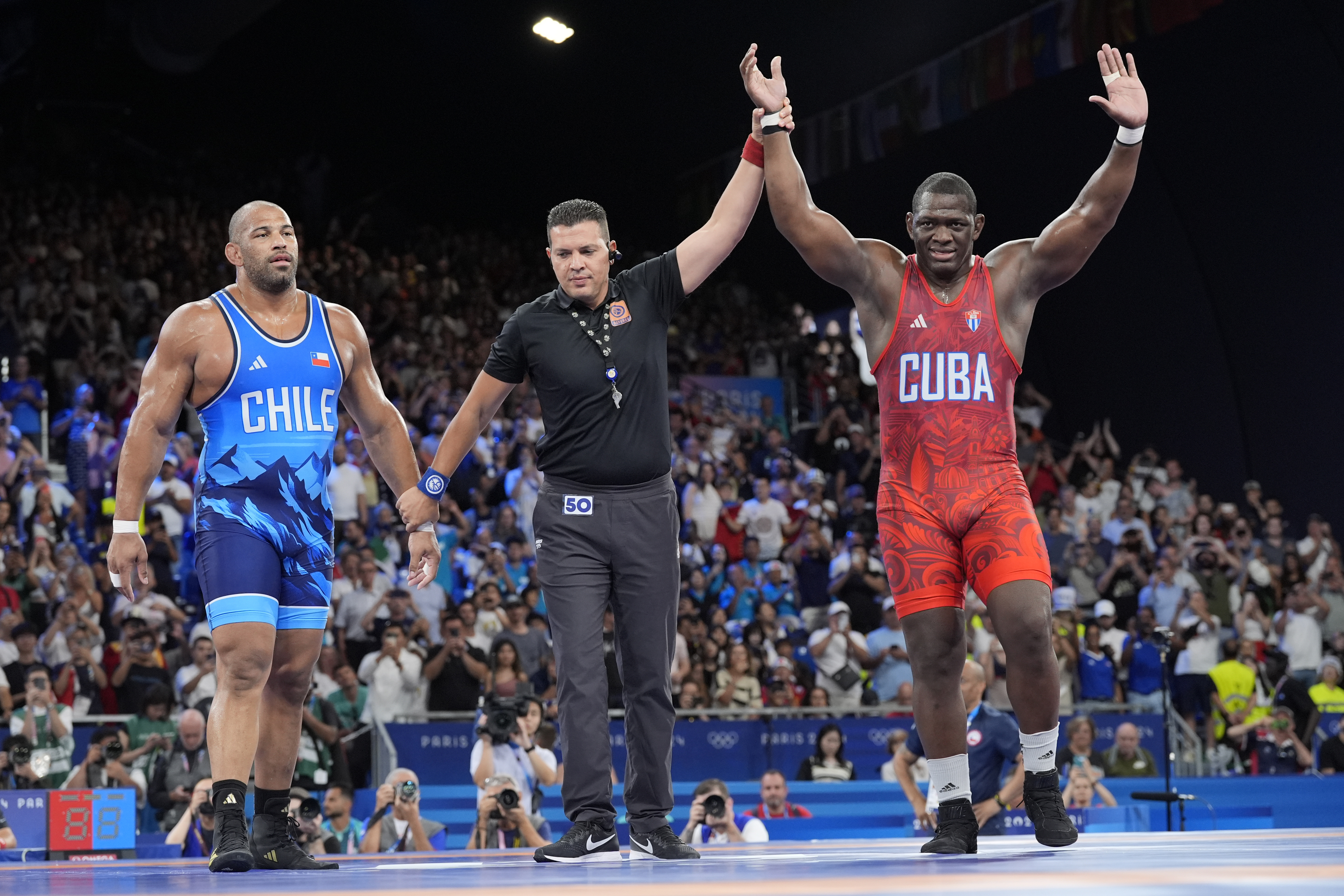 Cuba's Mijain Lopez Nunez celebrates after defeating Chile's Yasmani Acosta Fernandez during their men's Greco-Roman 130kg wrestling final match, at Champ-de-Mars Arena, during the 2024 Summer Olympics, Tuesday, Aug. 6, 2024, in Paris, France. 