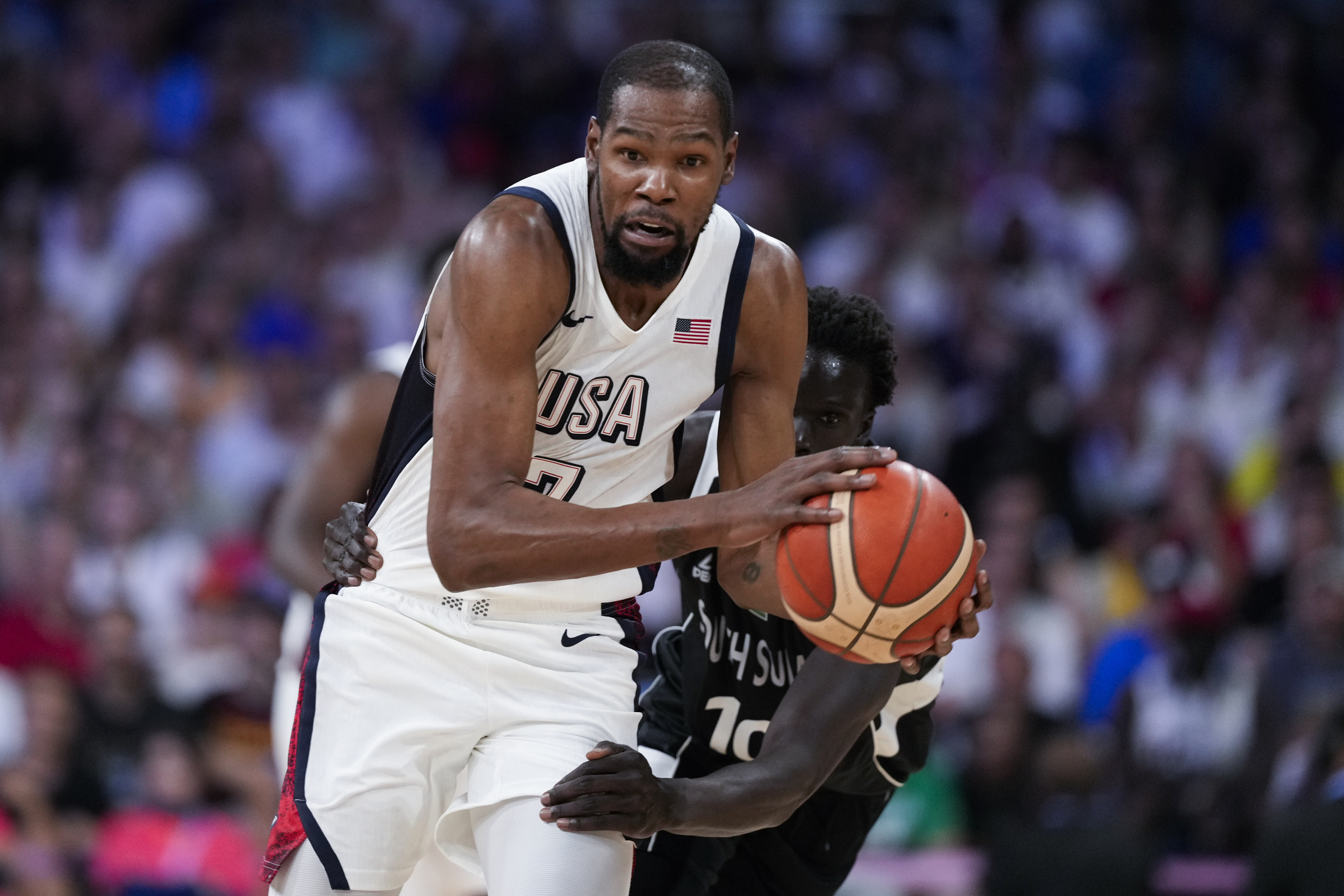 Kevin Durant, of the United States, is fouled by JT Thor, of South Sudan, in a men's basketball game at the 2024 Summer Olympics, Wednesday, July 31, 2024, in Villeneuve-d'Ascq, France.