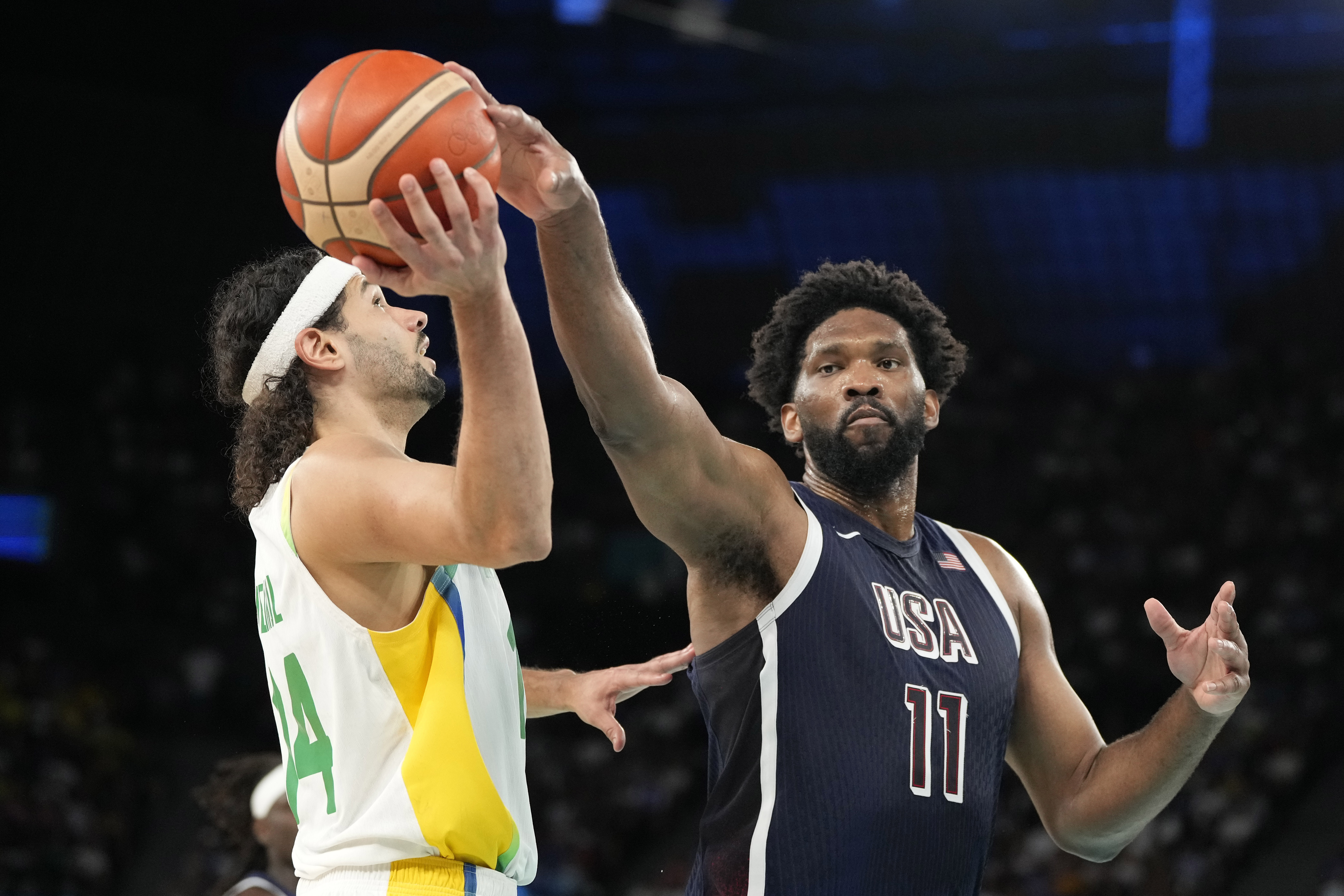 Brazil's Leo Meindl, left, has his shot blocked by United States' Joel Embiid during a men's basketball game at the 2024 Summer Olympics, Tuesday, Aug. 6, 2024, in Paris, France. 