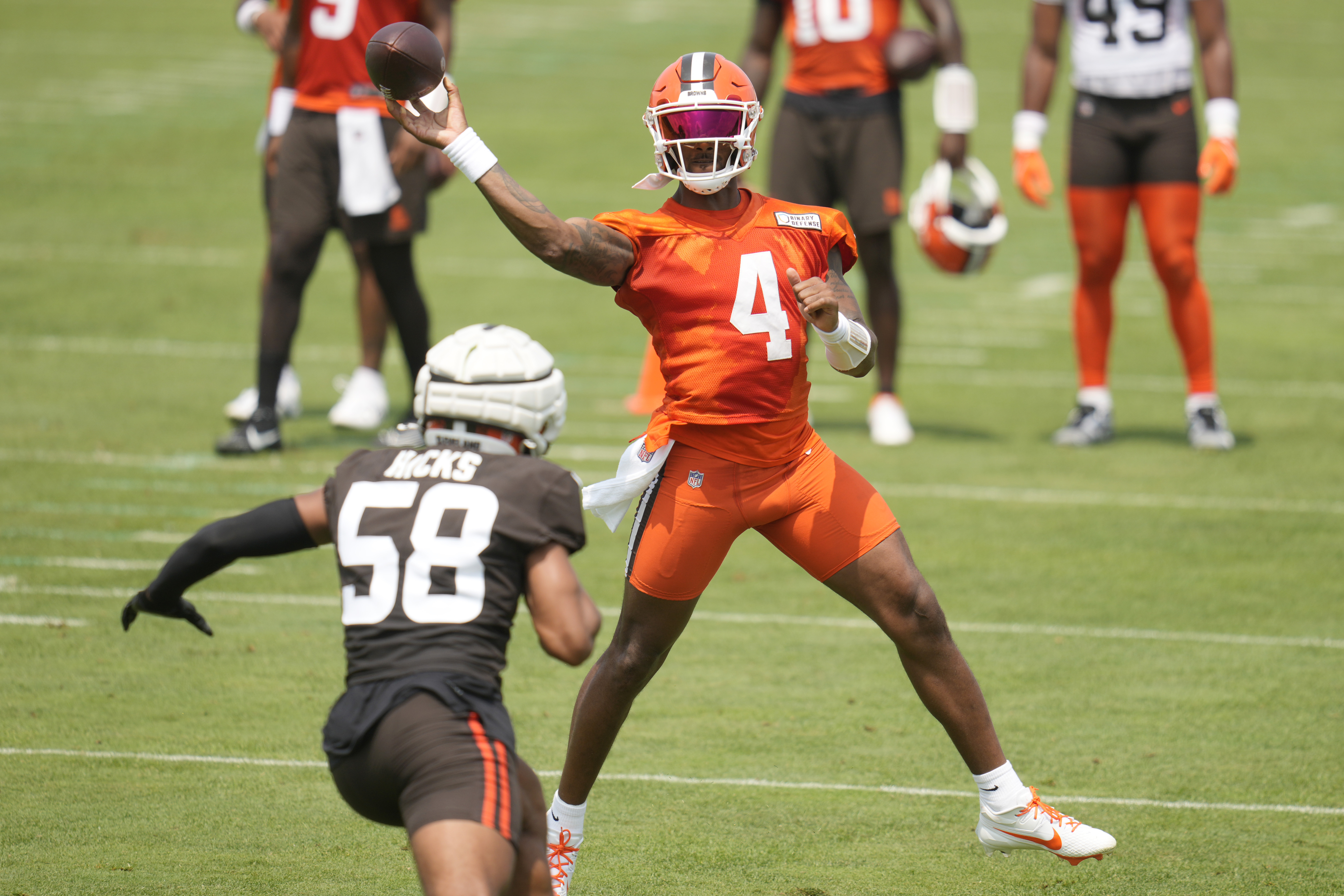 Cleveland Browns quarterback Deshaun Watson (4) passes under pressure from linebacker Jordan Hicks (58) during an NFL football training camp practice Friday, July 26, 2024, in White Sulphur Springs, W.Va., Saturday, July 27, 2024. 