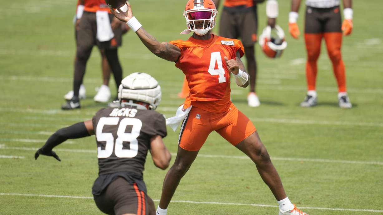 Cleveland Browns quarterback Deshaun Watson (4) passes under pressure from linebacker Jordan Hicks (58) during an NFL football training camp practice Friday, July 26, 2024, in White Sulphur Springs, W.Va., Saturday, July 27, 2024.
