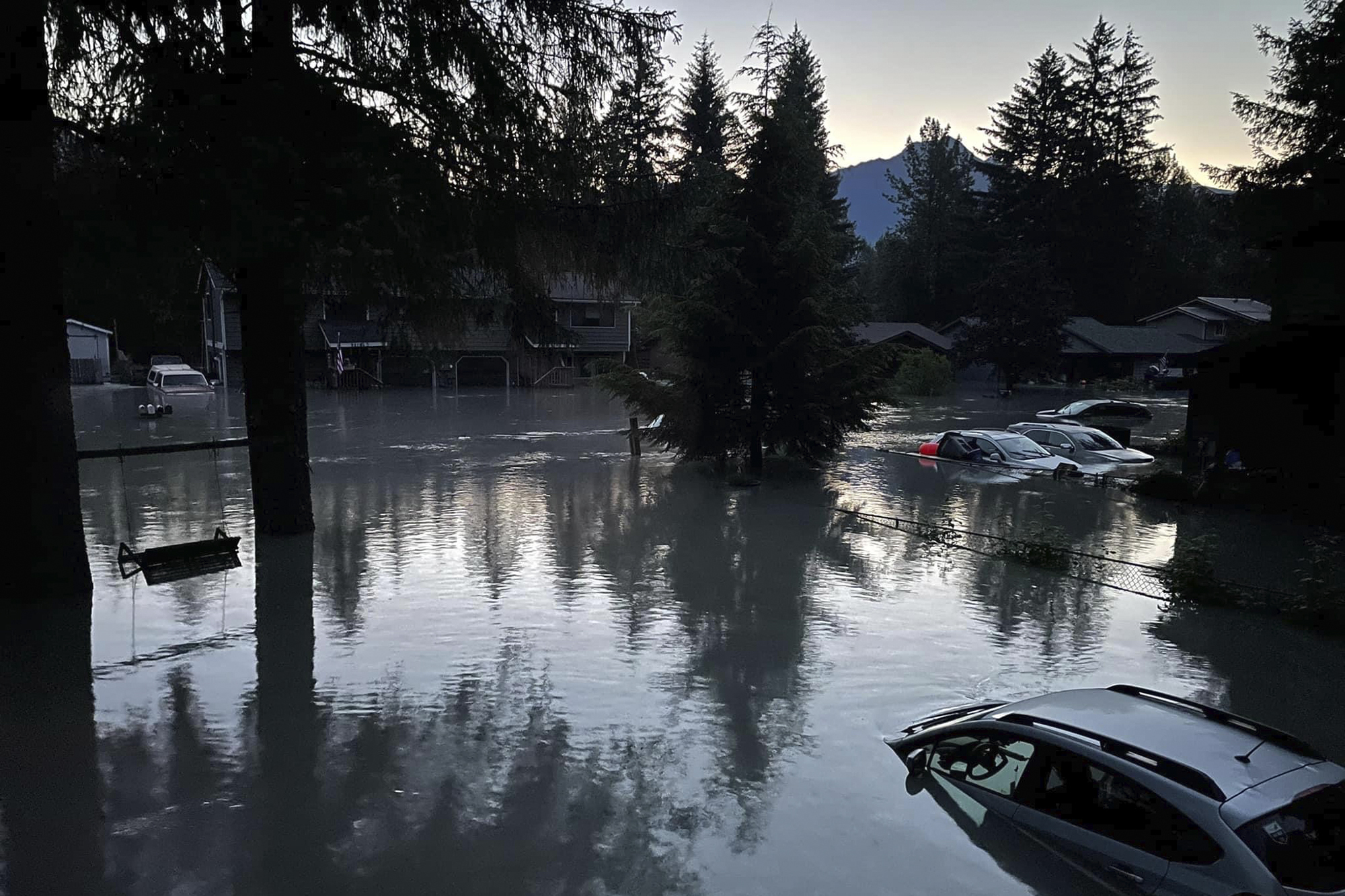 This image provided by the Alaska Department of Transportation and Public Facilities shows high water in a neighborhood in Juneau, Alaska, Monday, following an outburst of flooding from a lake dammed by the Mendenhall Glacier.