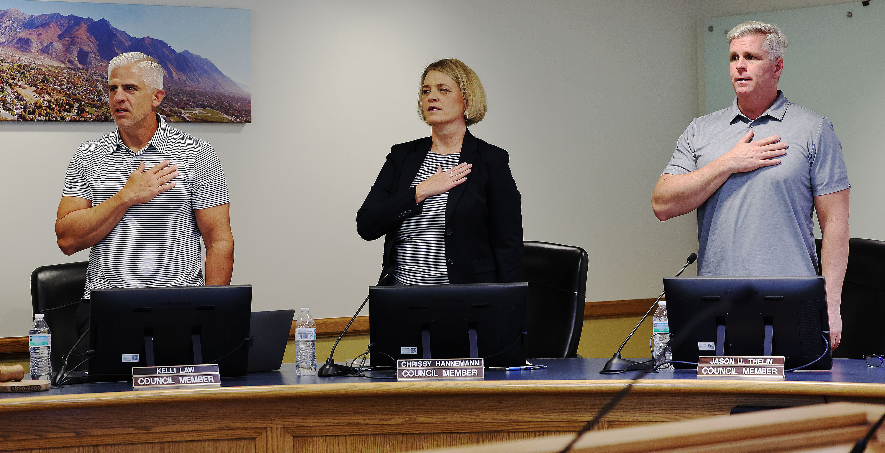 Alpine City Council members Kelli Law, Chrissy Hannemann and Jason Thelin recite the Pledge of Allegiance prior to voting on a resolution to place the creation of a new school district on the ballot in Alpine on Tuesday. Five other cities in northern Utah County also passed resolutions.